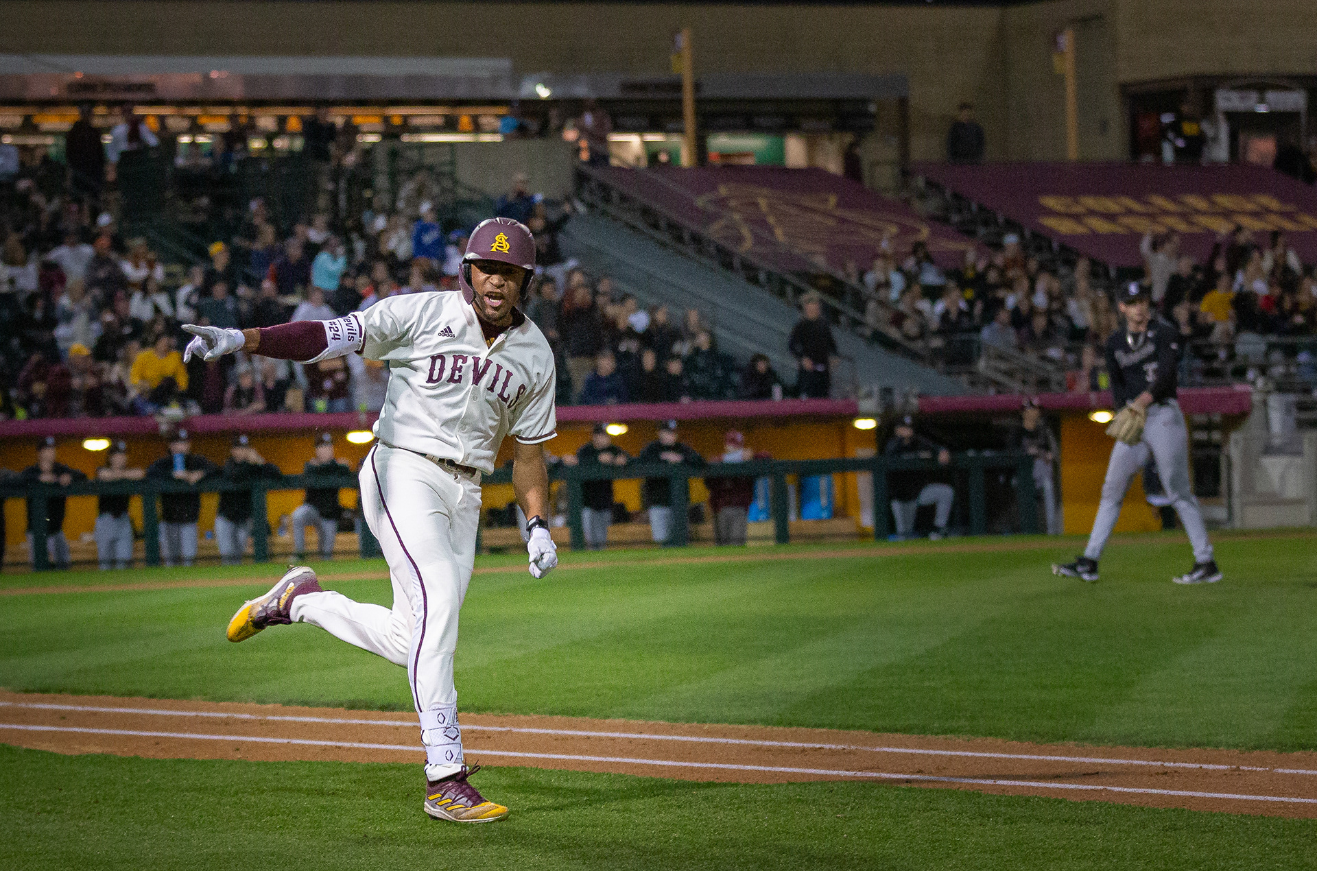 Isaiah Jackson, Arizona State University outfielder, points and yells towards his dugout after hitting a home run  at Phoenix Municipal Stadium on Friday, February 16, 2024 in Phoenix, Arizona.