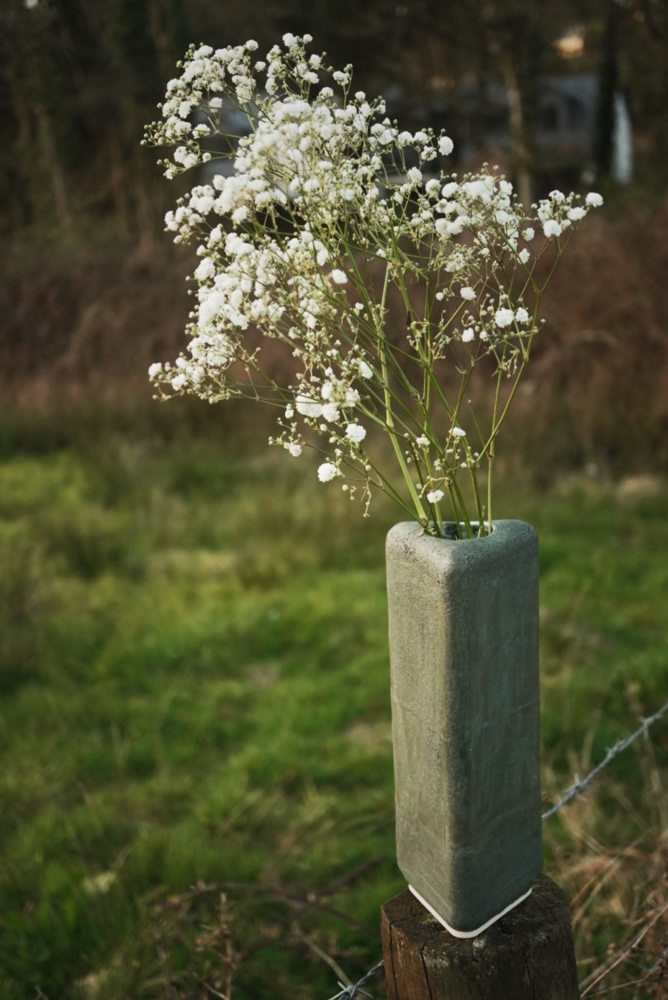 Black triangle vase on the fence post
