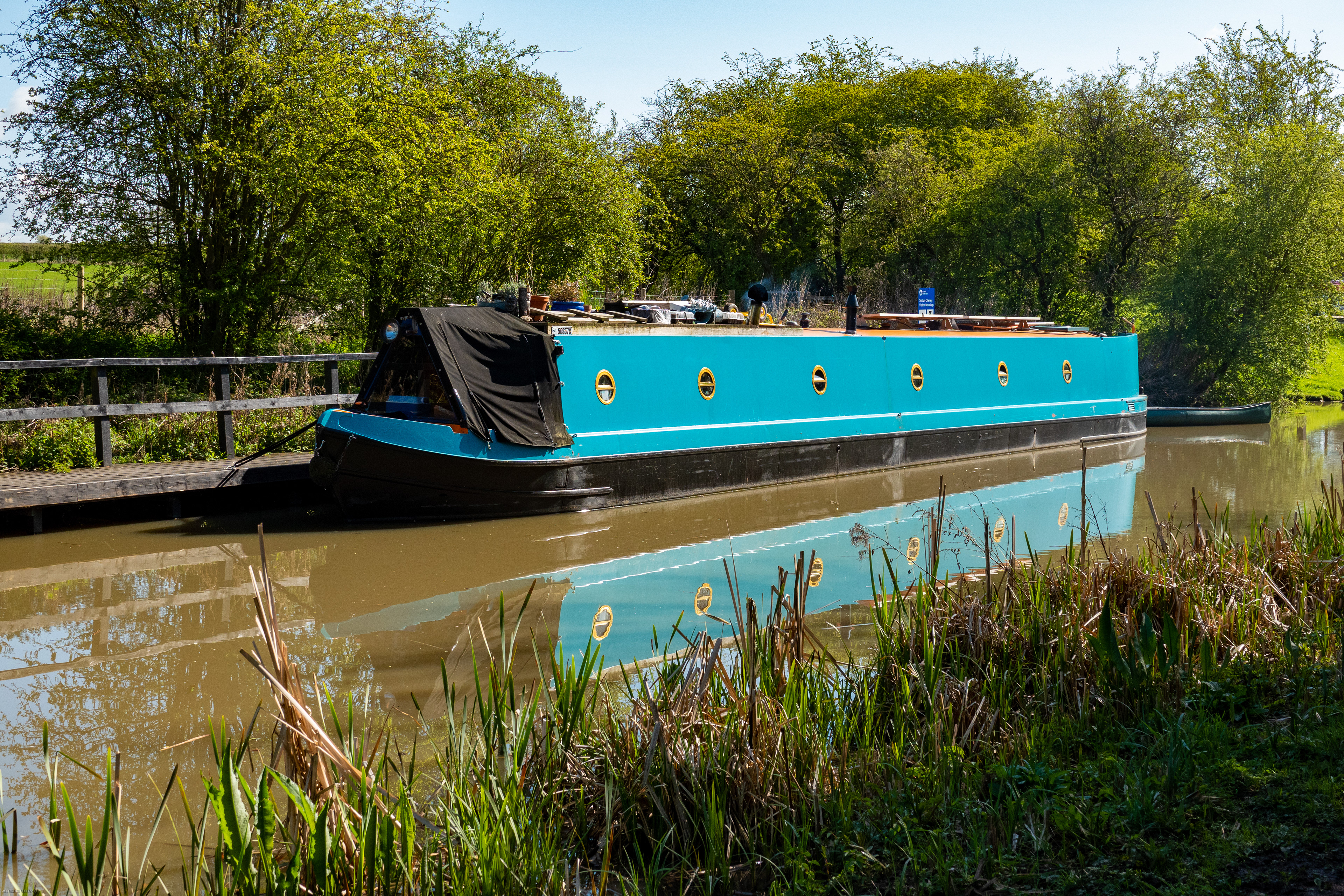 Reflections of a blue narrow boat