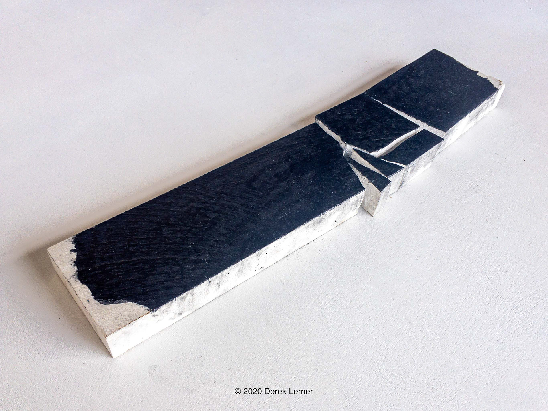 Fracture 14s, Derek Lerner 2020 Graphite, engineered marble, and varnish 3.5" x 17" x 1" (8.89cm x 43.18cm x 2.54cm)