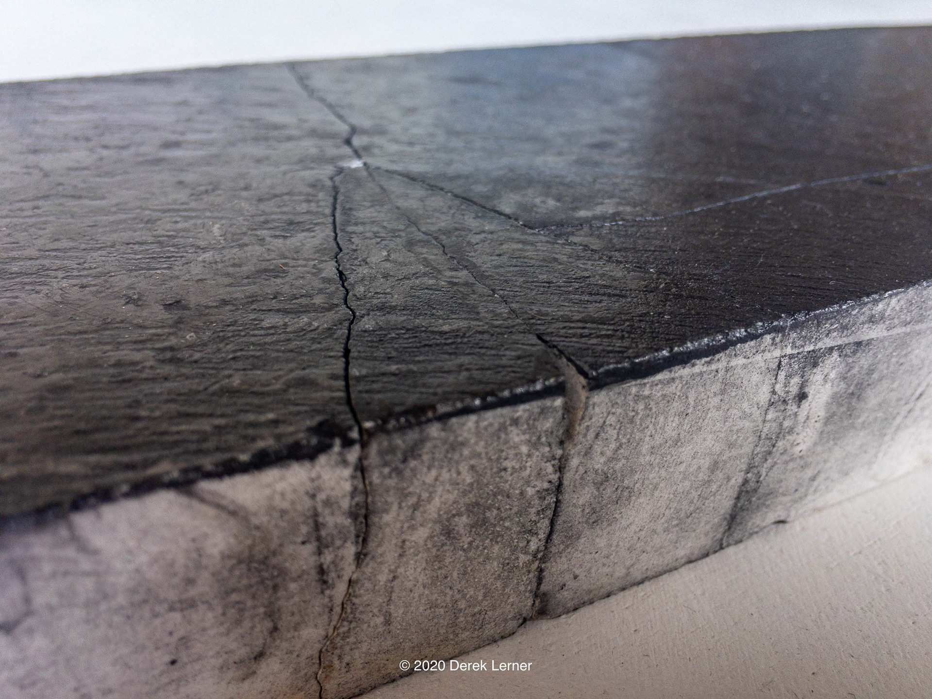 Detail of Fracture 14s, Derek Lerner 2020 Graphite, engineered marble, and varnish 3.5" x 17" x 1" (8.89cm x 43.18cm x 2.54cm)