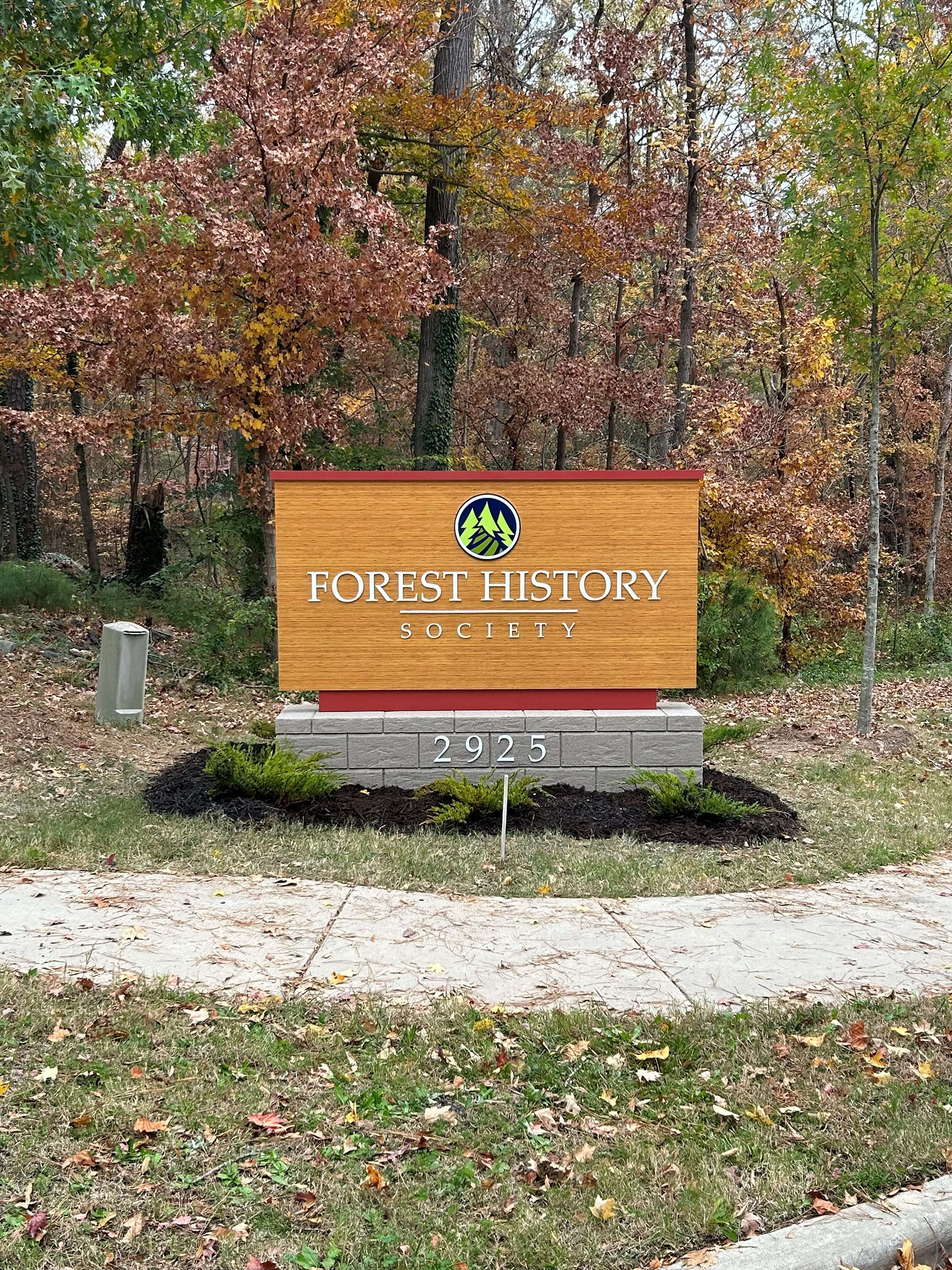 Steel frame monument w/ Alpolic Timber Series wrapped faces and dimensional graphics, faux stone base with dimensional building address • Forest History Society • Durham, NC