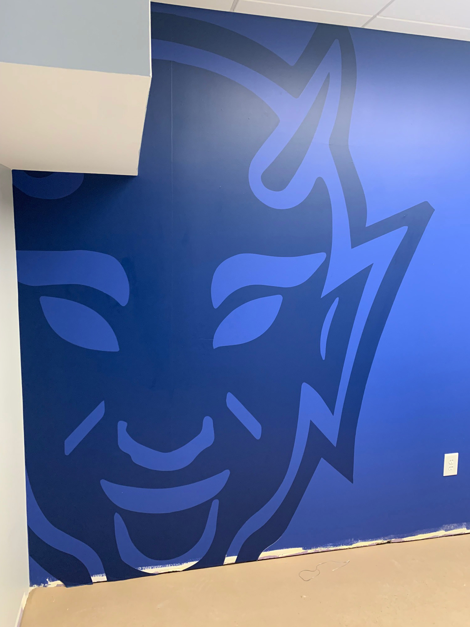 Duke Field Hockey • Coaches' Locker Room, step 1: Blue Devil wall graphic (large format digital print, hand cut, on blue painted wall, closeup)