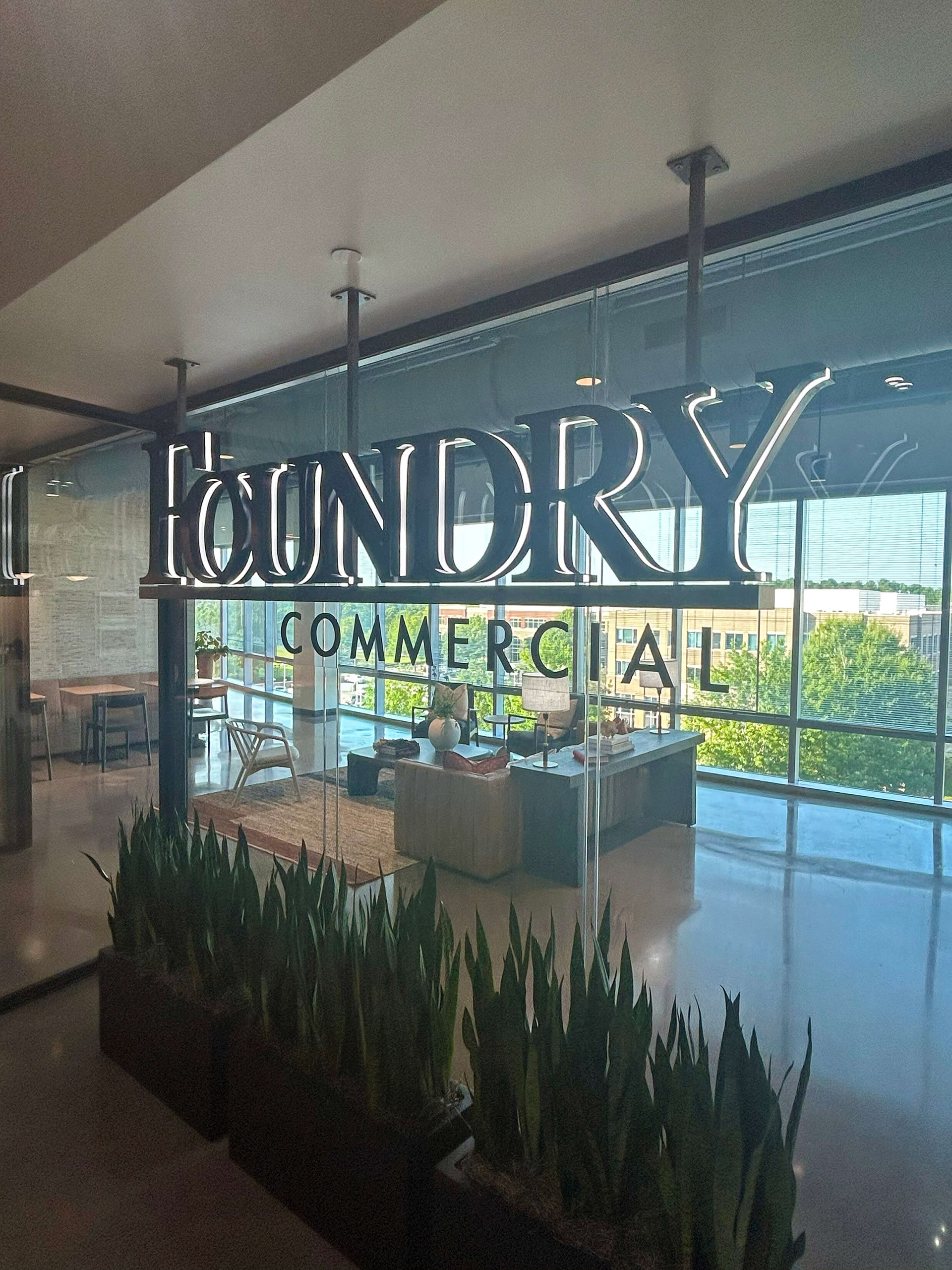 Suspended aluminum logo for Foundry Commercial real estate company • white edge-lit channel letters with black faces