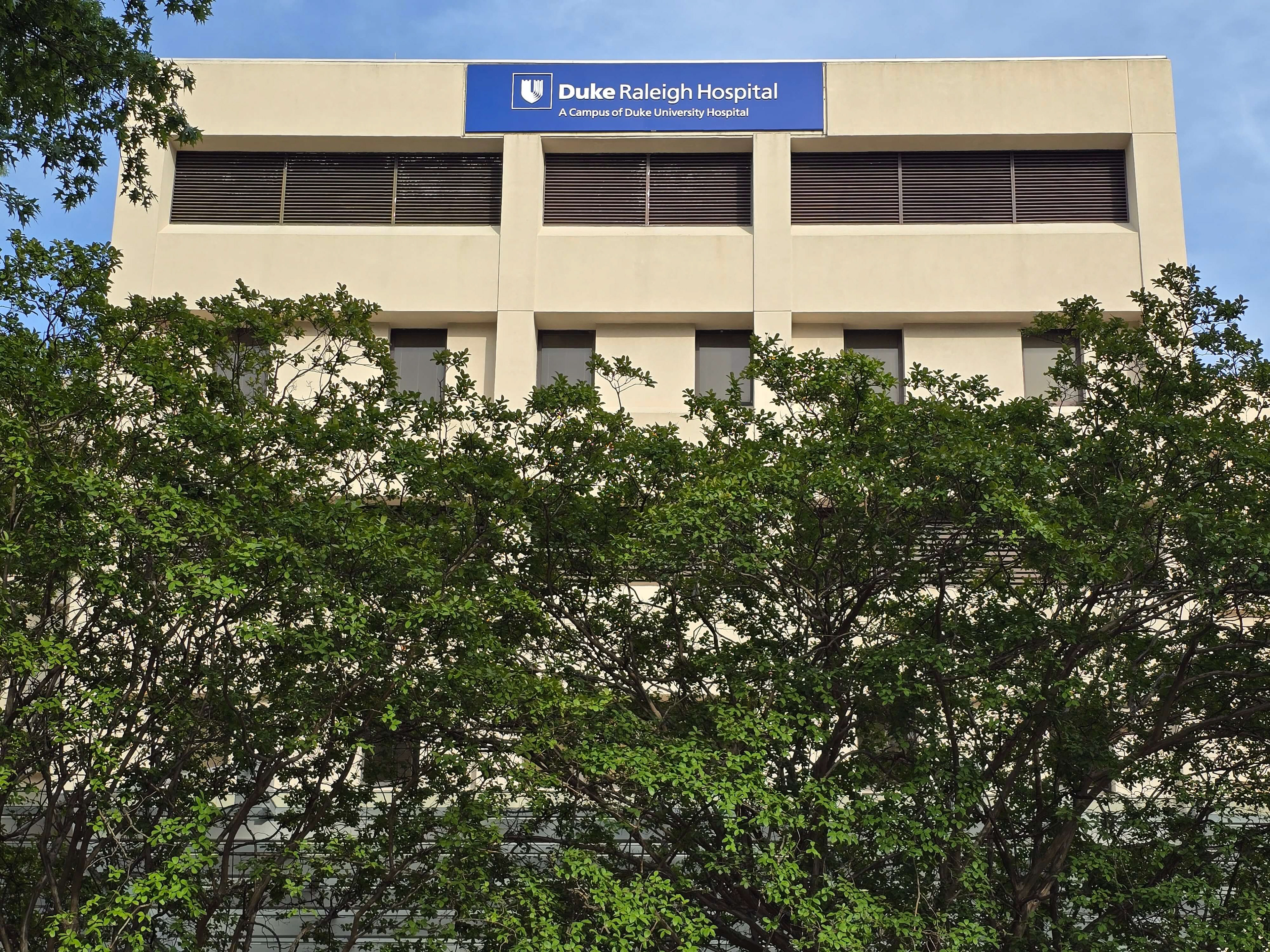 New non-illuminated aluminum logo and letters, painted white, on existing pan-formed panel (retrofit to replace previous logo) • Duke Raleigh Hospital • Raleigh, NC