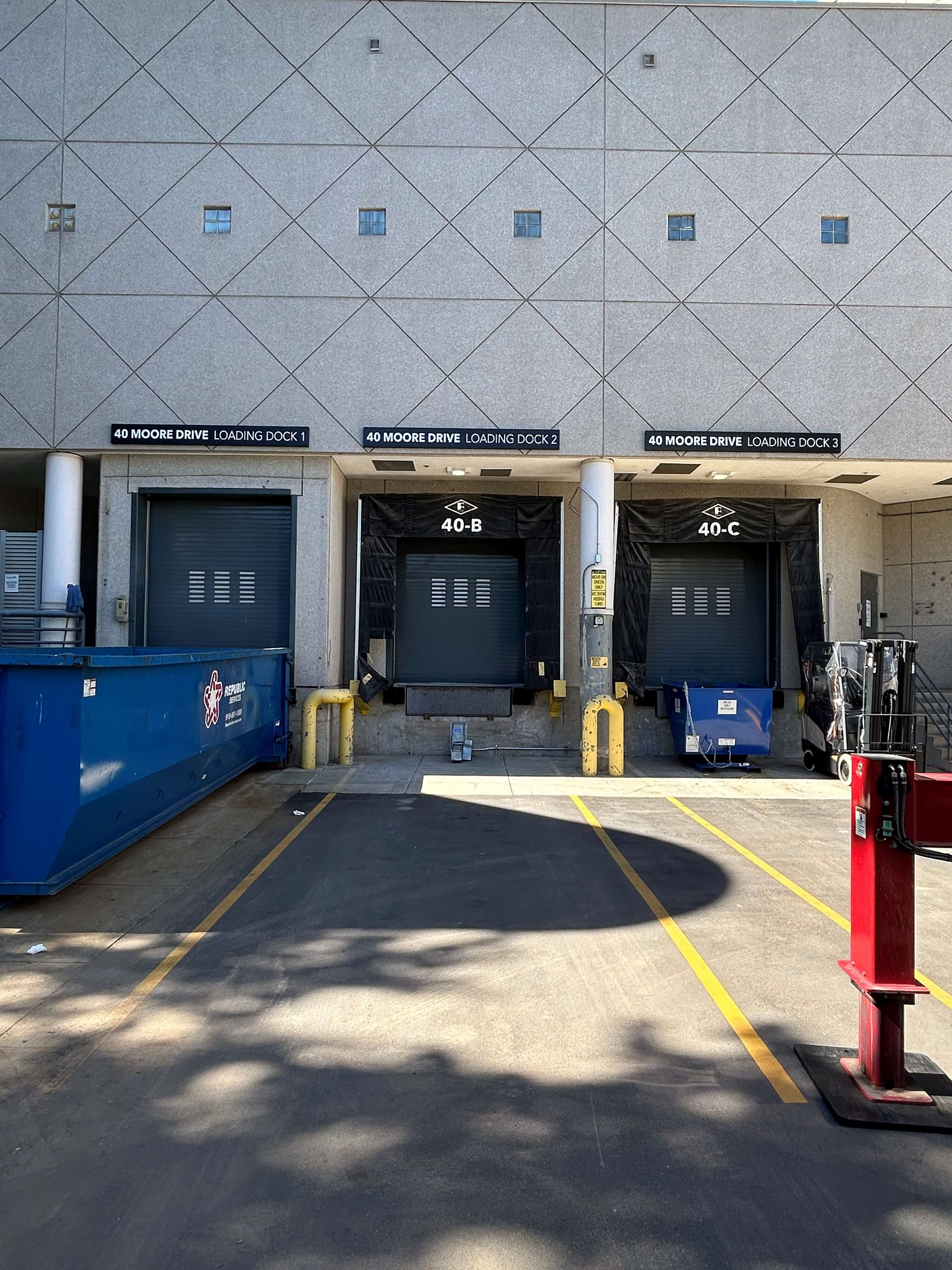 Pan-formed aluminum dock signs with 1st-surface applied matte white vinyl copy • Alexandria Real Estate • Durham, NC
