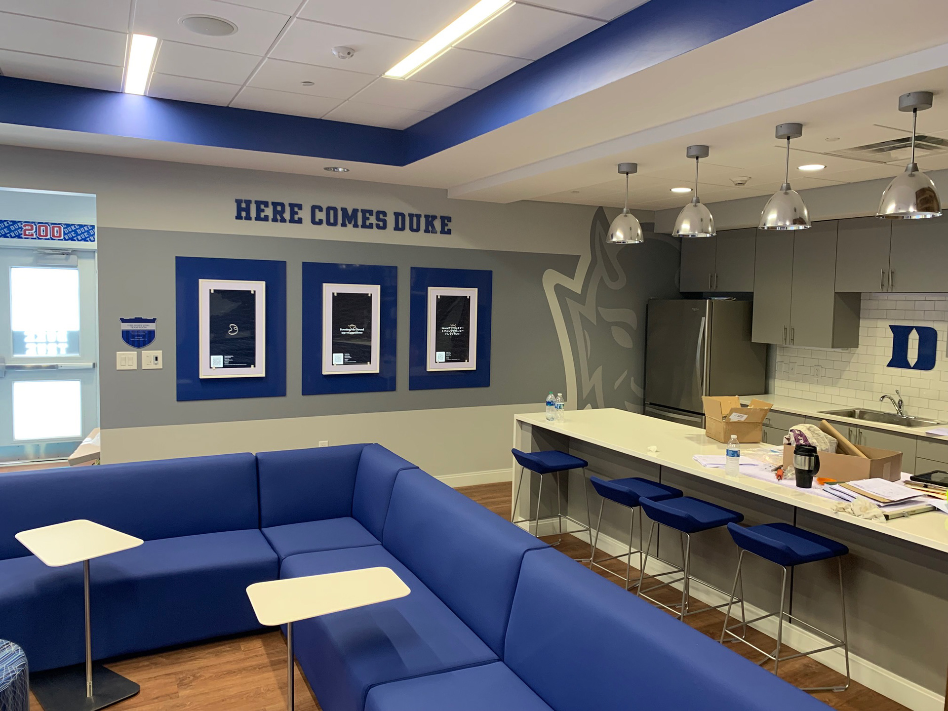 Duke Field Hockey • Team Room/Kitchen, complete (includes Terri Farner Burke donor plaque, painted acrylic "HERE COMES DUKE" letters and Duke "D" logo, and NETGEAR Meural digital canvases)