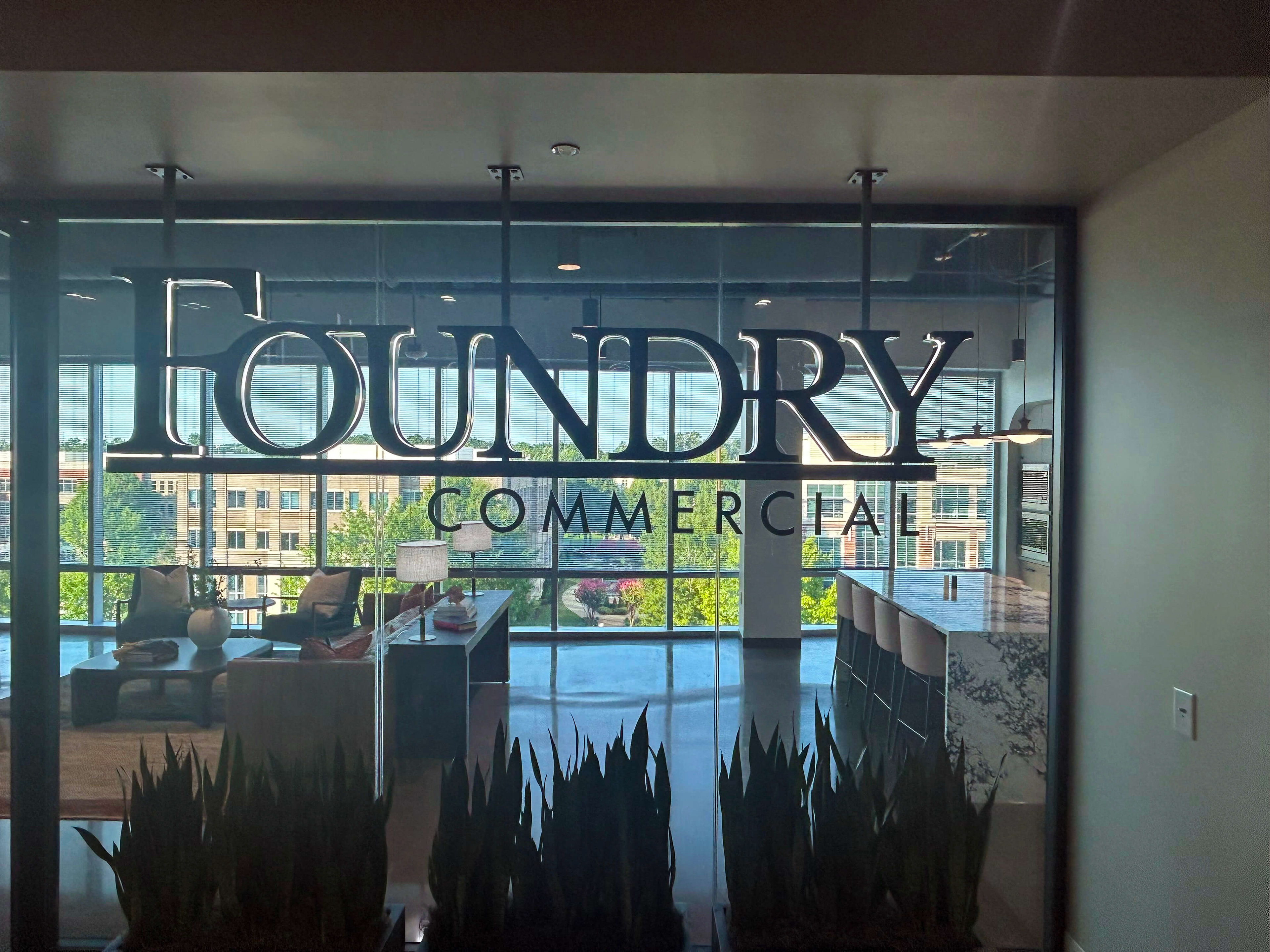 Suspended aluminum logo for Foundry Commercial real estate company • white edge-lit channel letters with black faces
