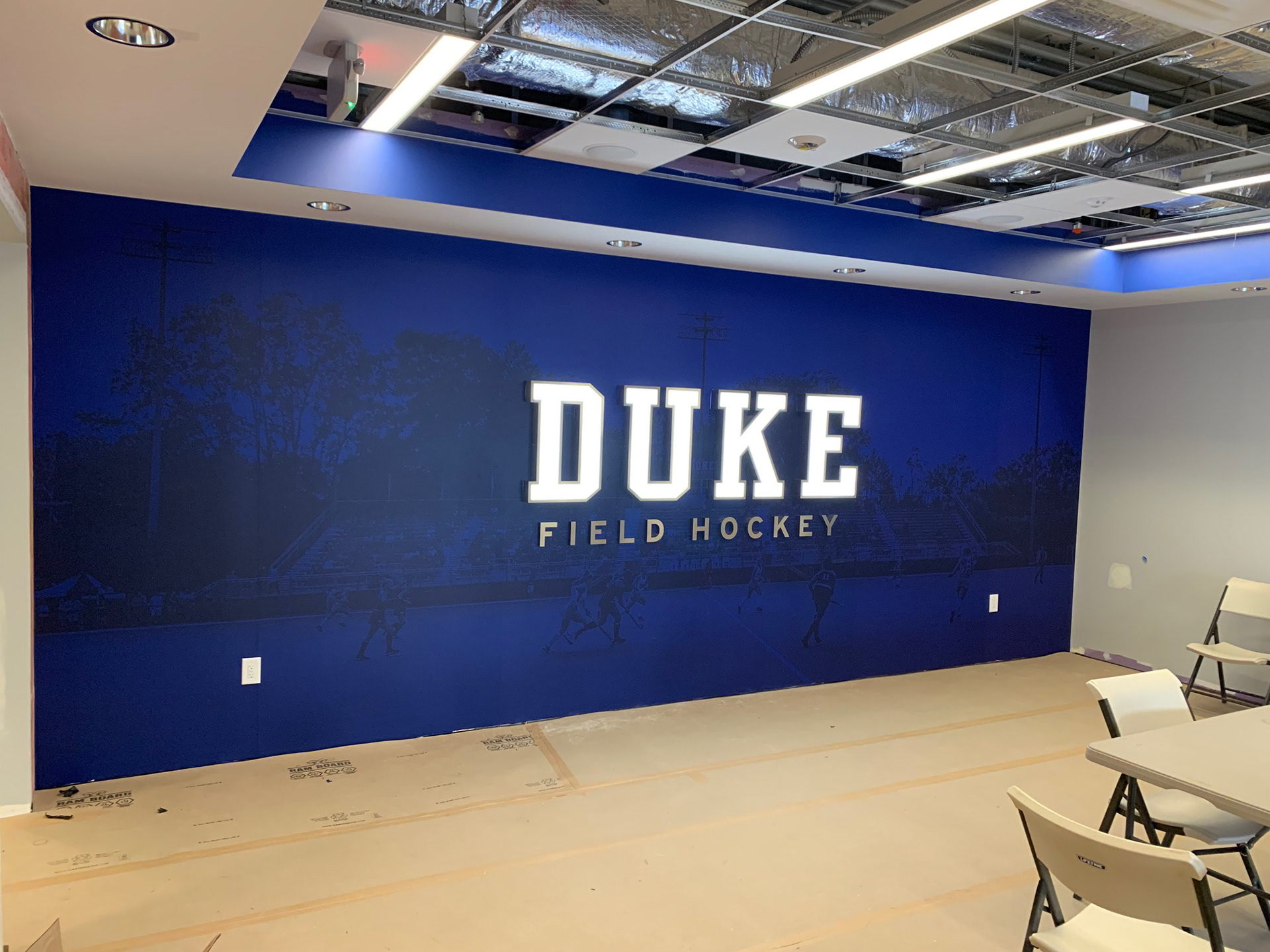 Duke Field Hockey • Lounge, step 2: wall letters (illuminated acrylic/stainless steel "DUKE" plus stainless steel "FIELD HOCKEY")