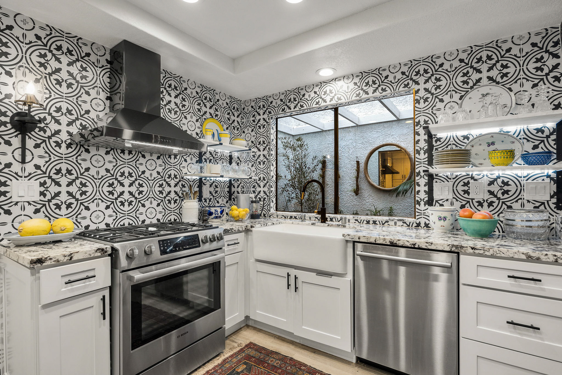 Upper cabinets replaced with marble shelves to bring style to a budget project.