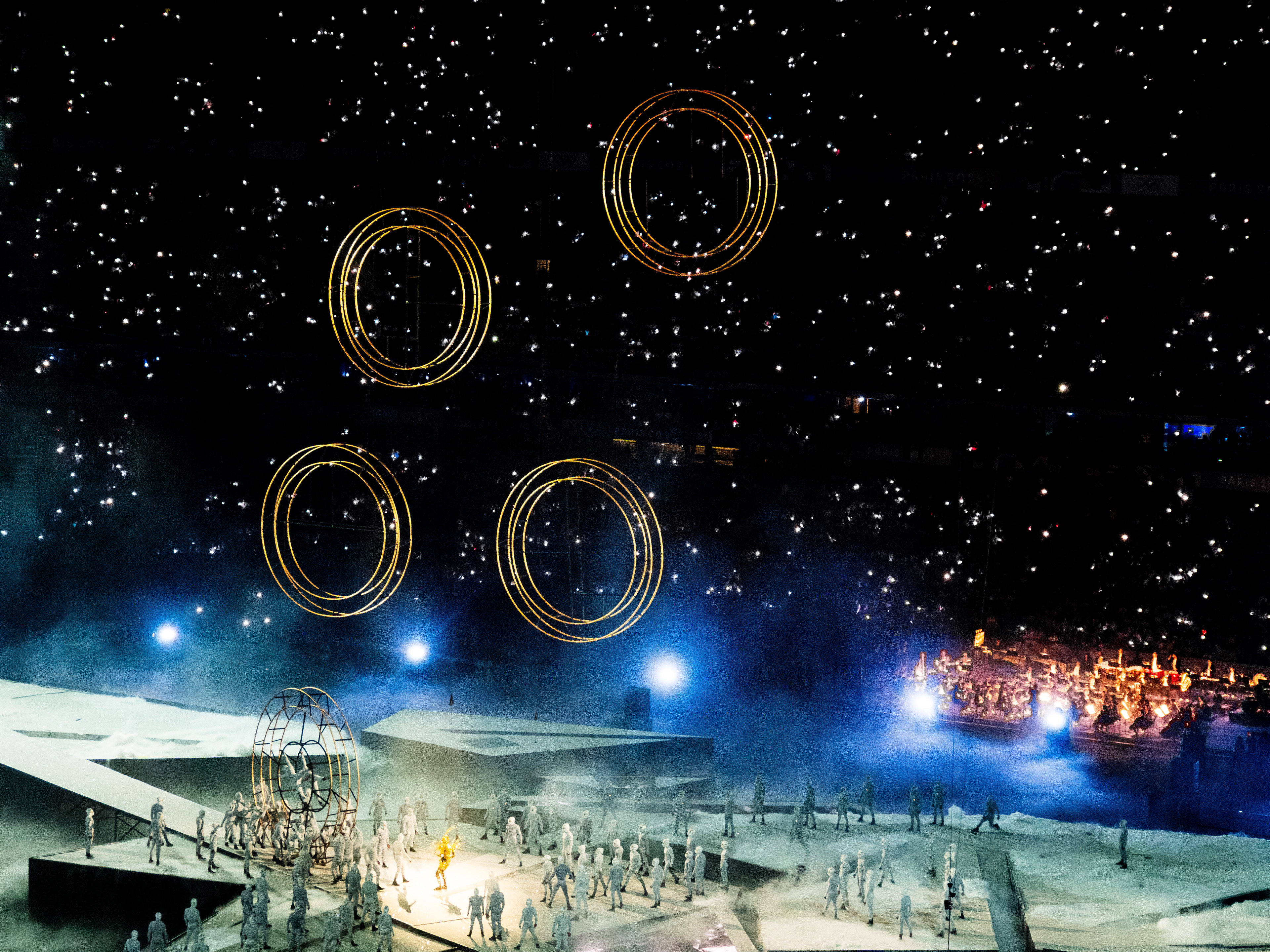 Elevation des anneaux olympiques, tribune illuminée d'étoiles