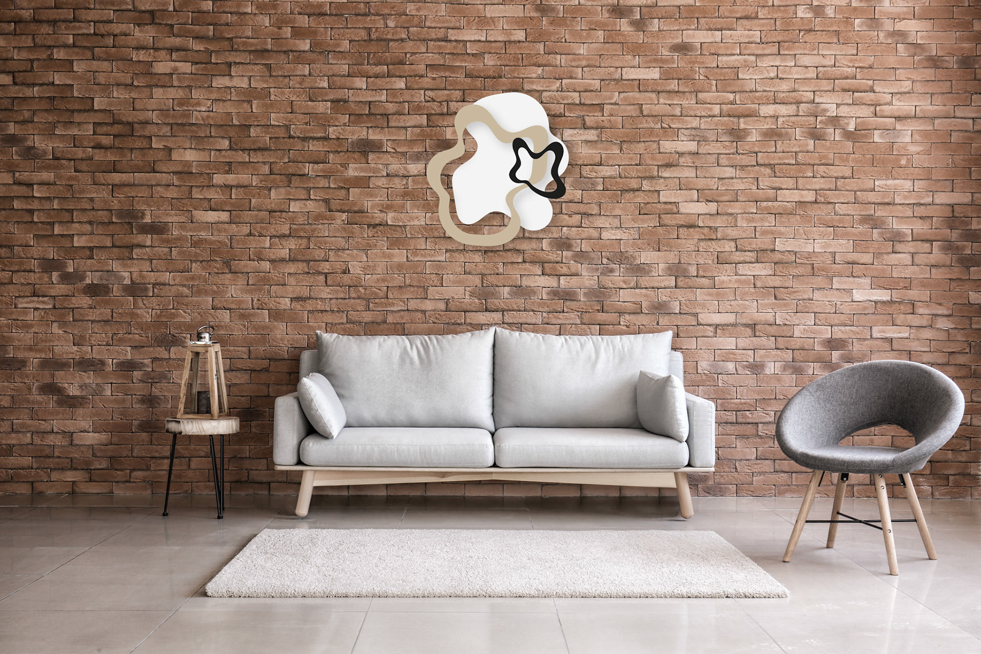 Modern interior of living room with comfortable sofa and armchair near brick wall