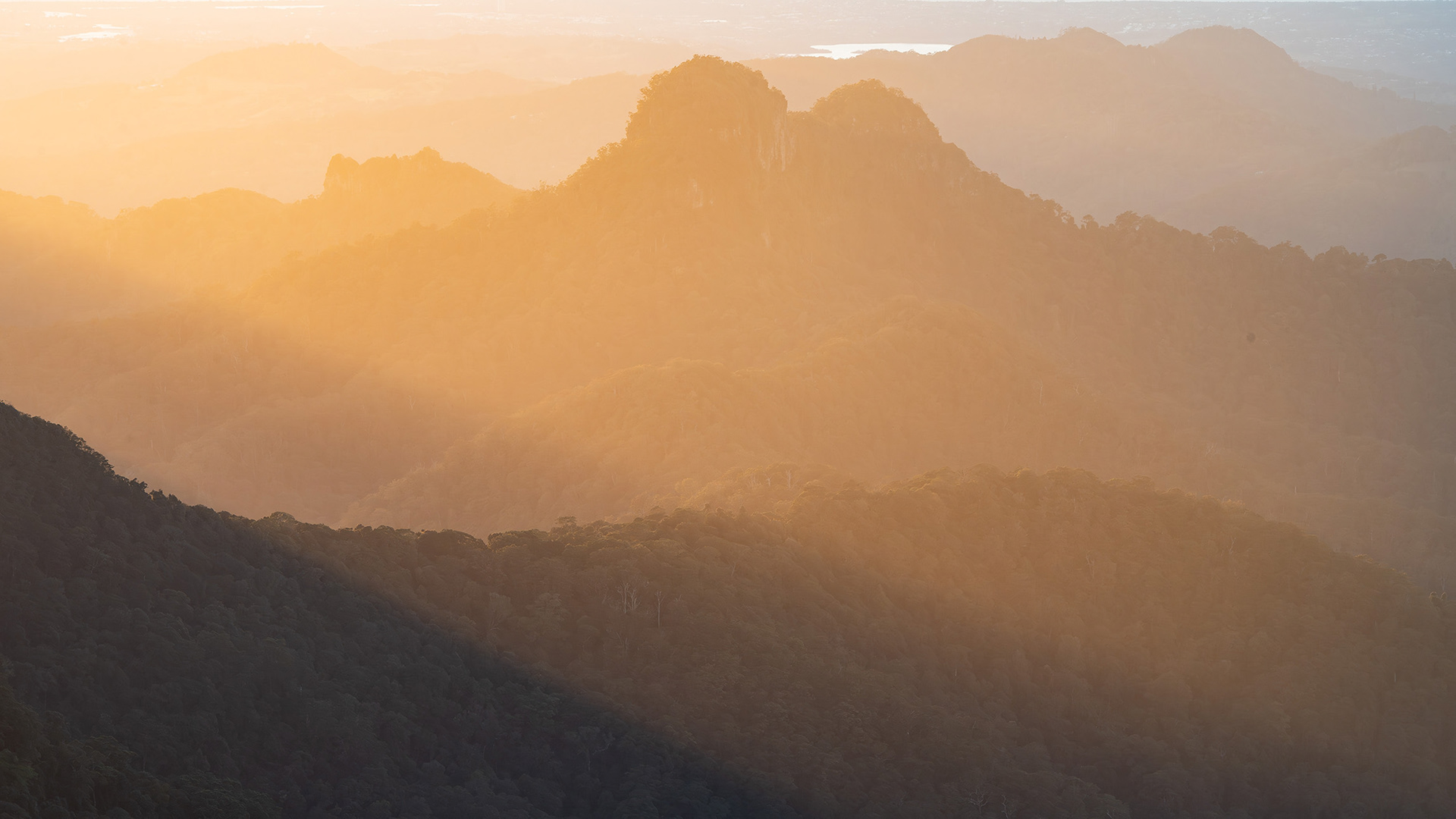 Zooming into the distant mountains of Springbrook National Park.