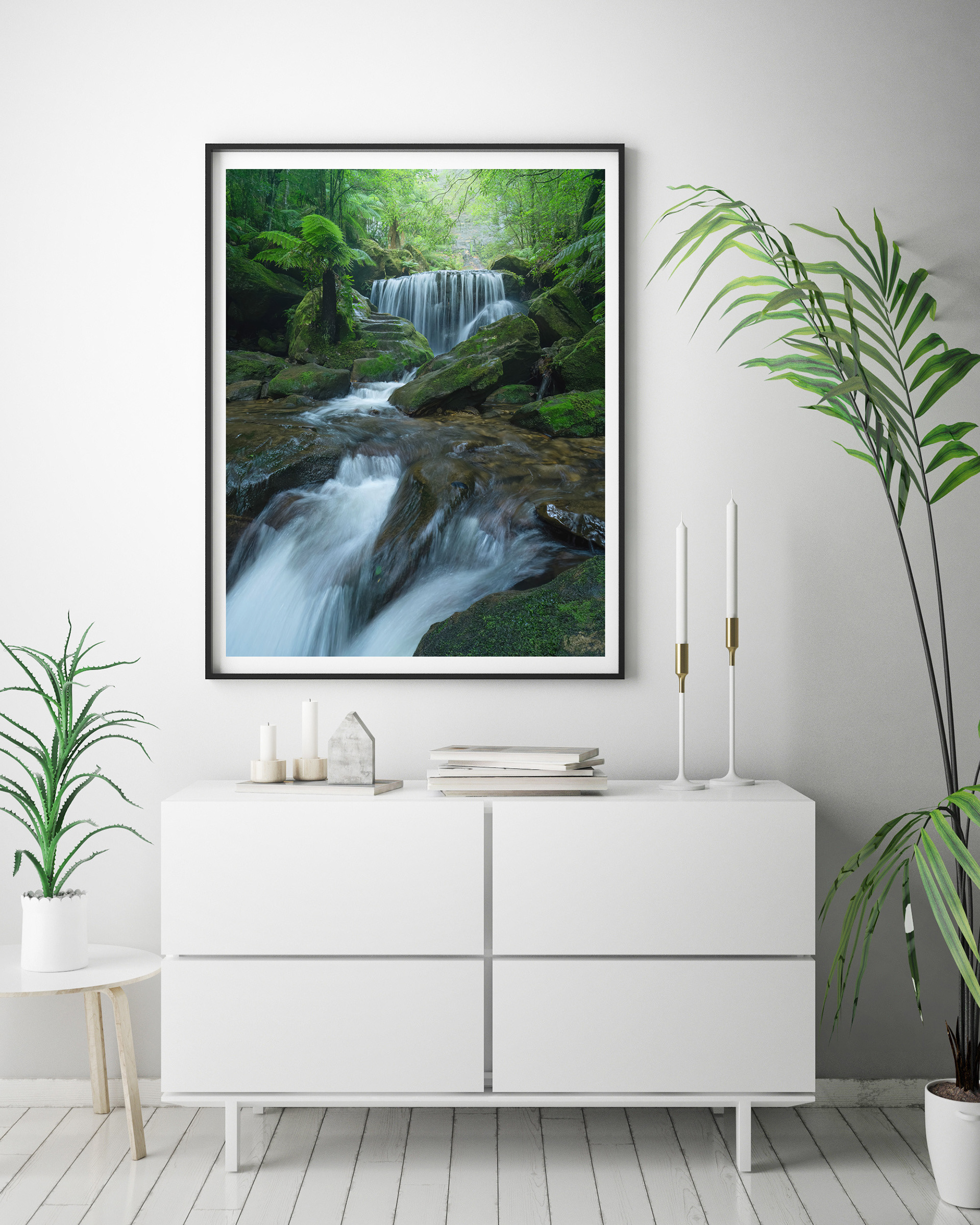 A framed print of a picturesque waterfall in a lush rainforest setting, available for purchase.