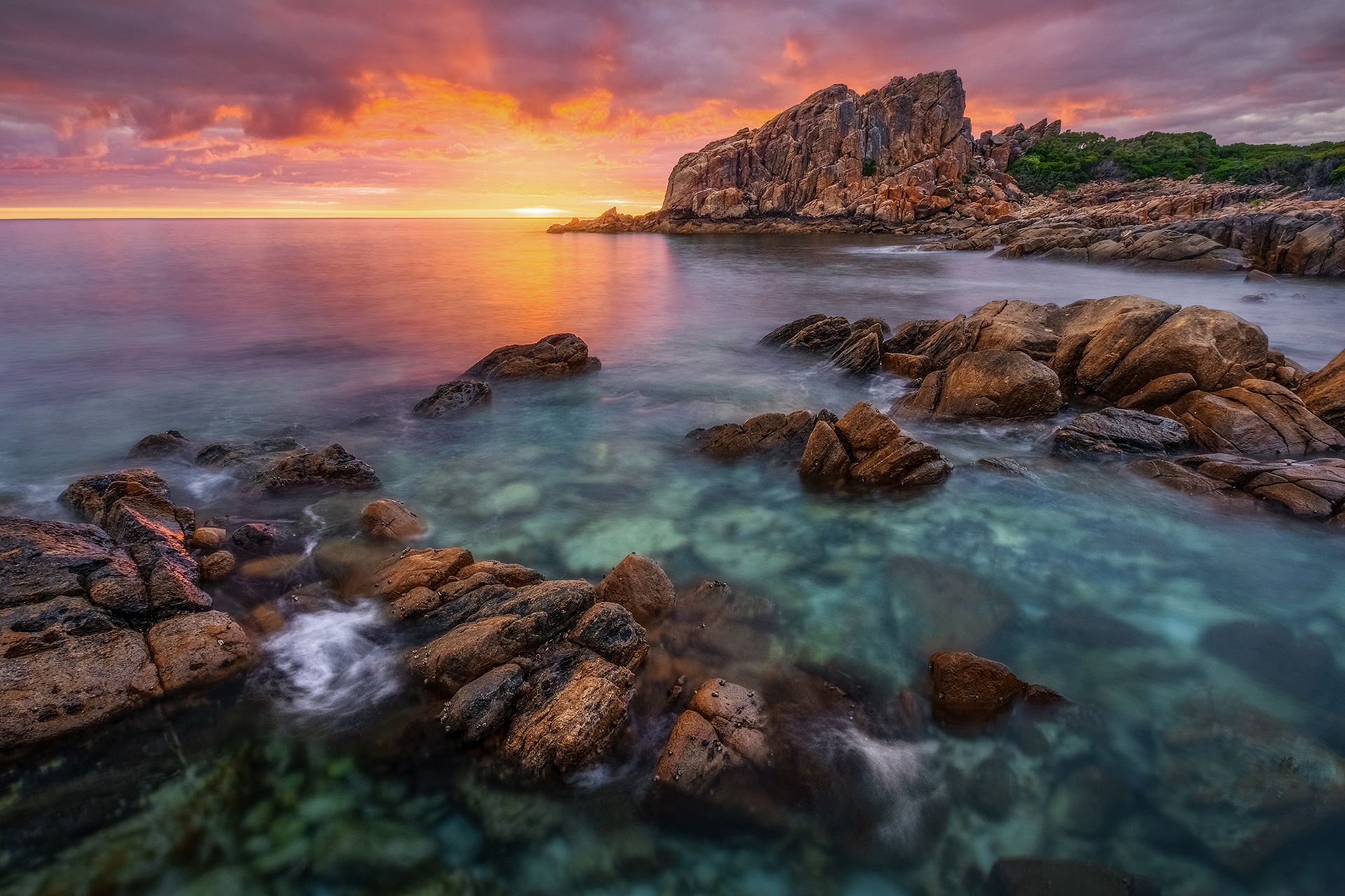 A colourful sunrise erupts behind the iconic Castle Rock Beach in Dunsborough, WA.