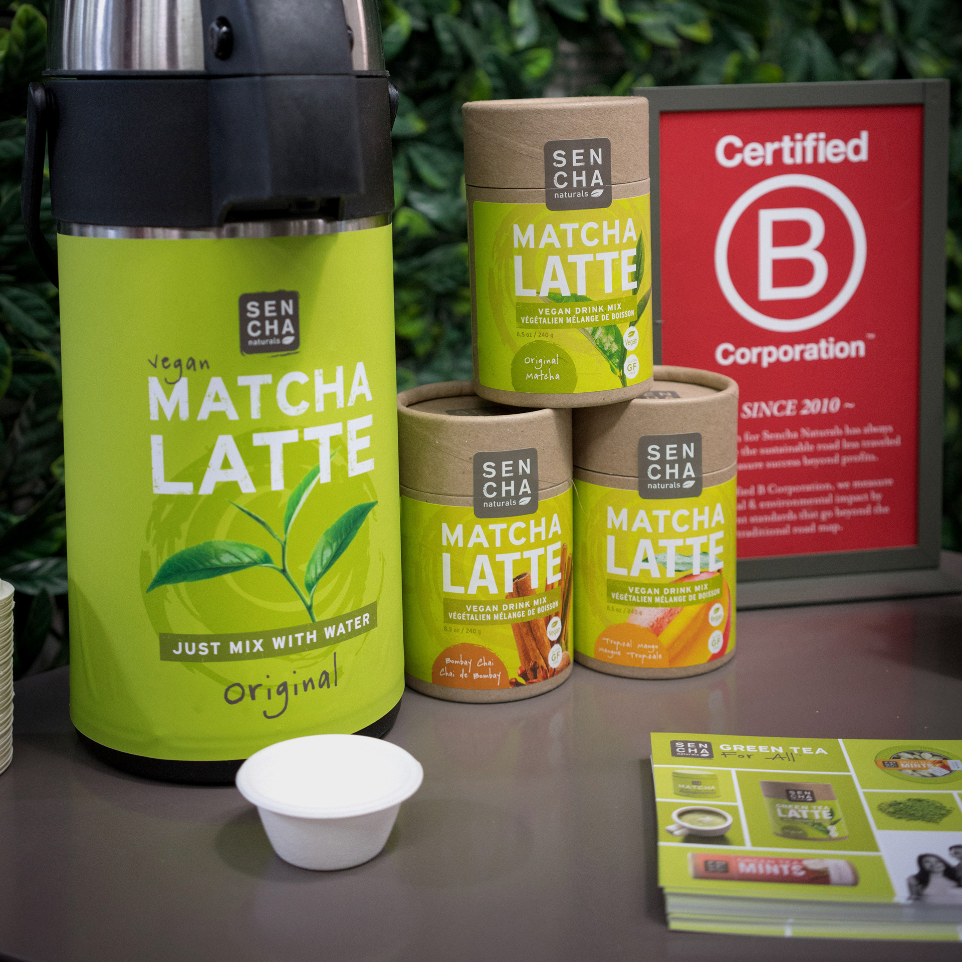 Matcha latte sampling station near B-Corporation sign