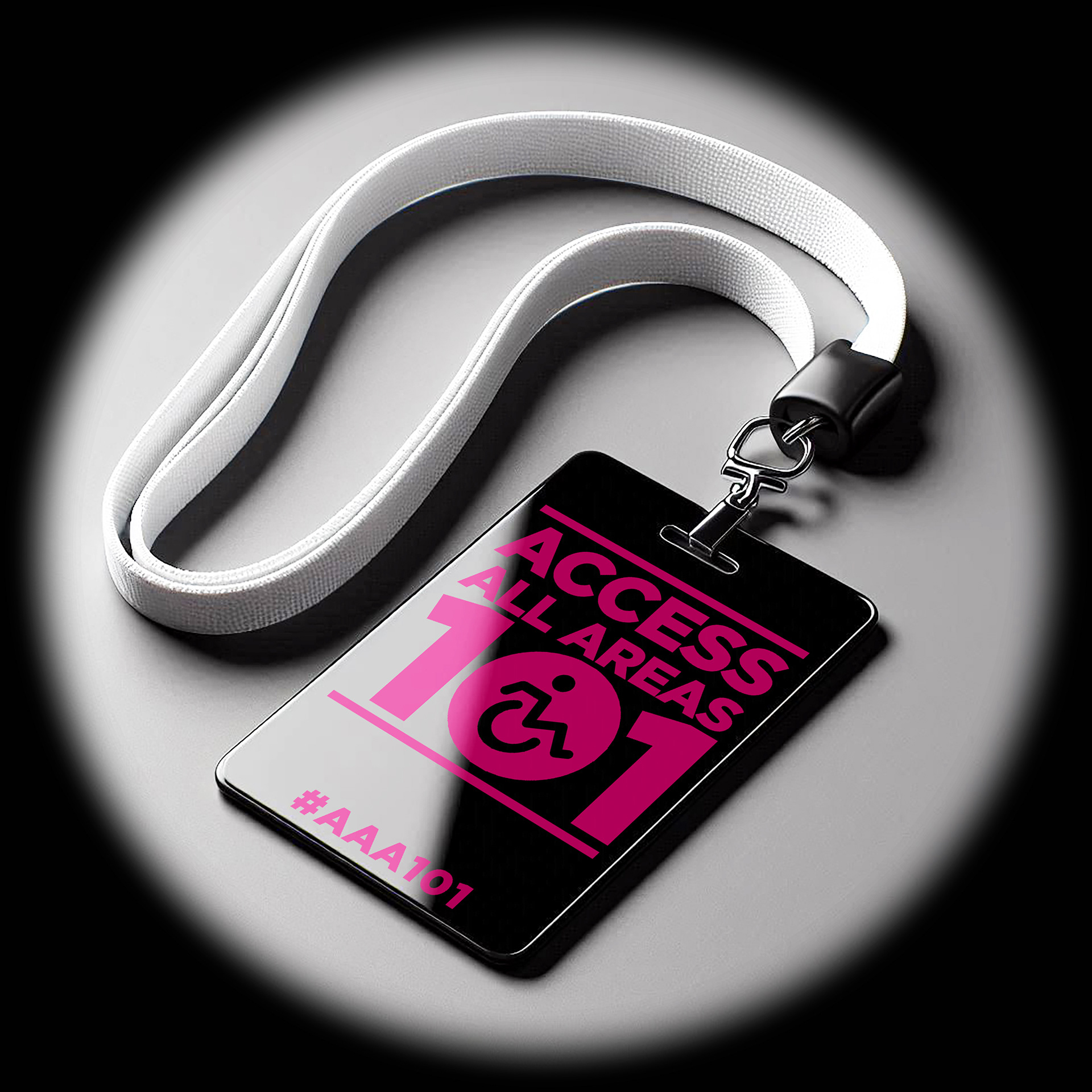 A black glossy acrylic security pass with pink text reading ‘Access All Areas 101’ #AAA101. The pass is attached to a white fabric lanyard and is laid on a grey background