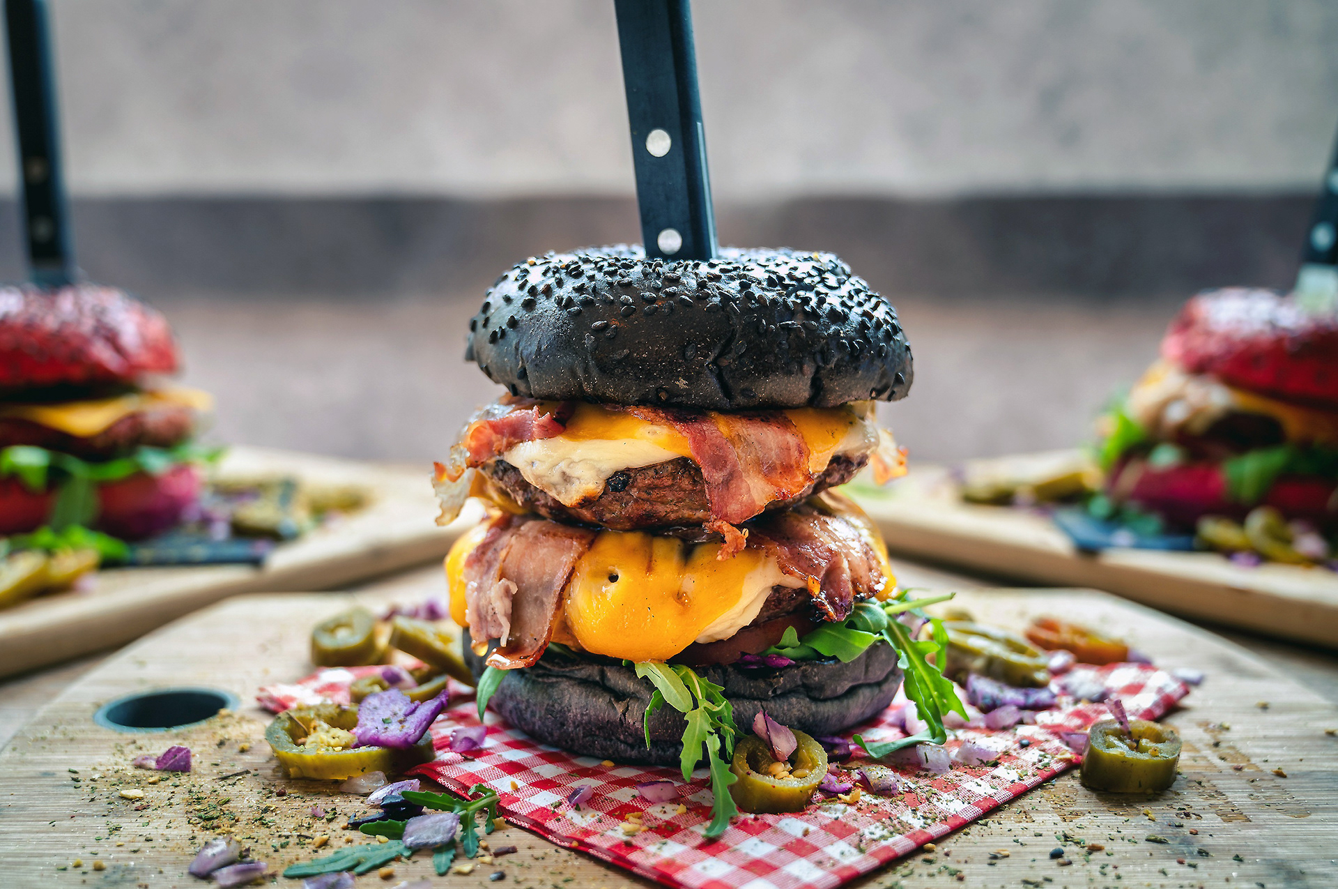 Close-up macro shot of a specialty wagyu beef burger featuring dripping sauce and crisp lettuce, rustic wooden tabletop background, professional food styling for social media content.