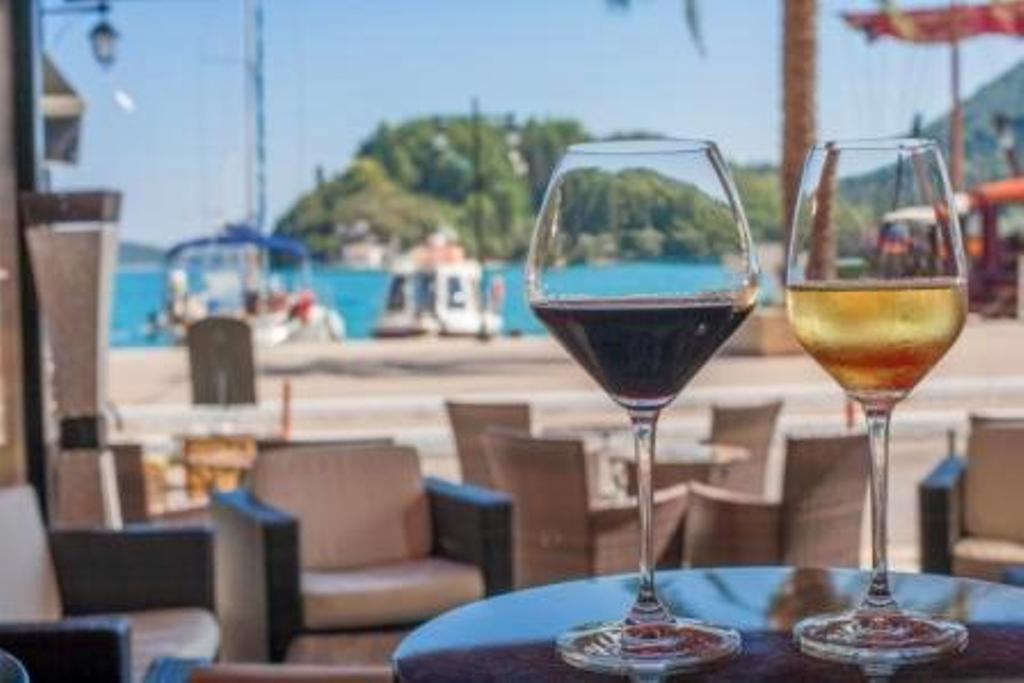 Sip a chilled glass of local wine by the water and watch the boats drift by — the perfect pause between sea and supper