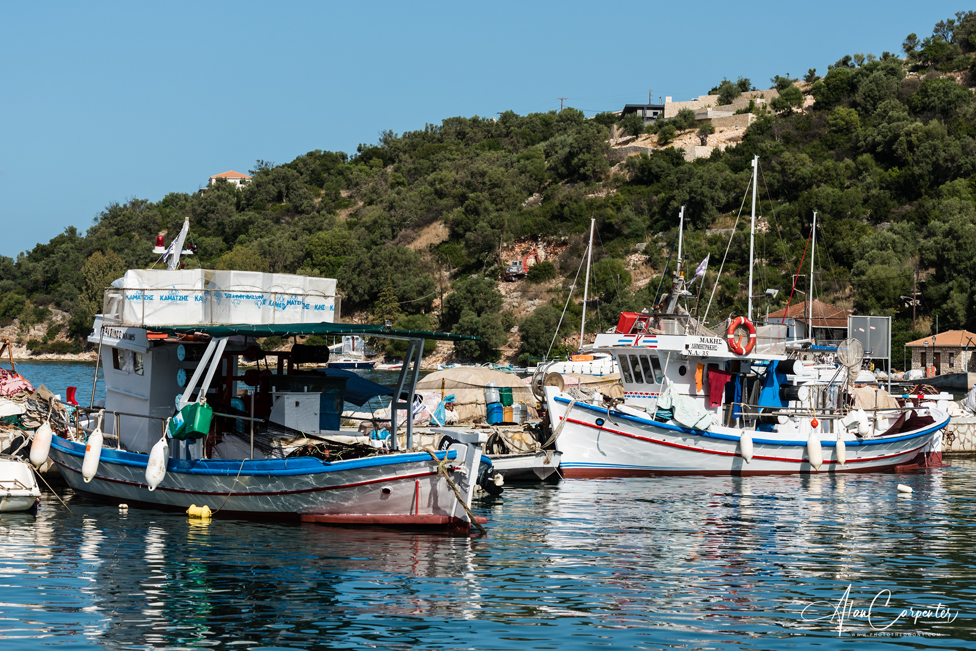Colourful fishing boats like these are part of everyday island life — perfect to spot on a family boat trip across to Meganisi