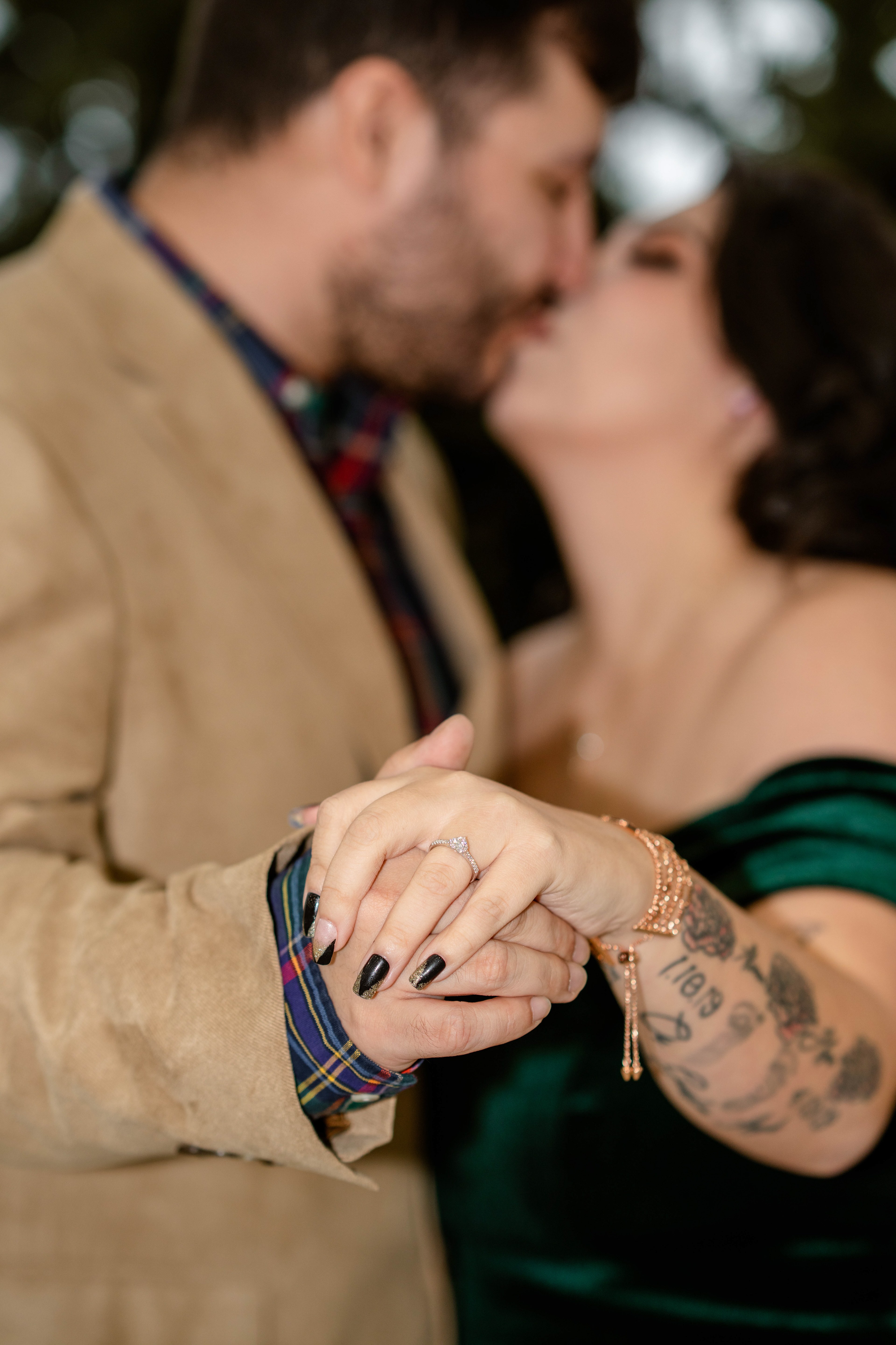 Fiancés kiss while showing off the engagement ring 