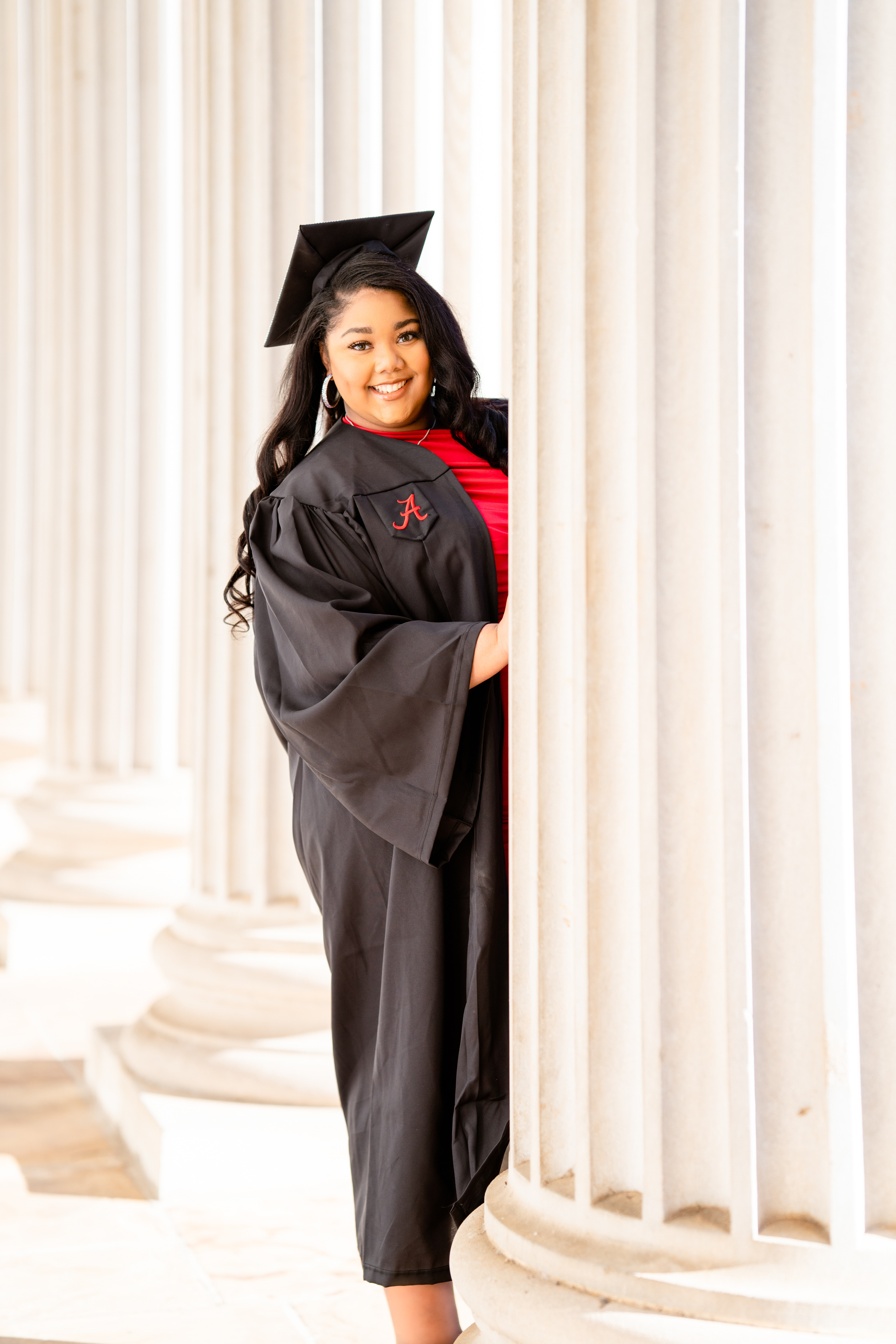Graduating student between the columns on campus