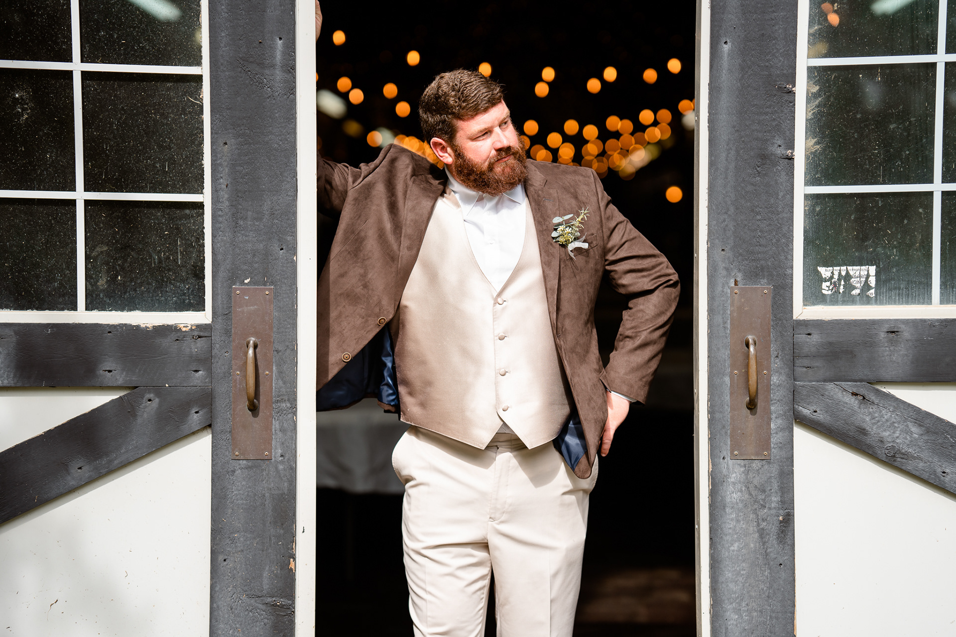 Groom between barn doors