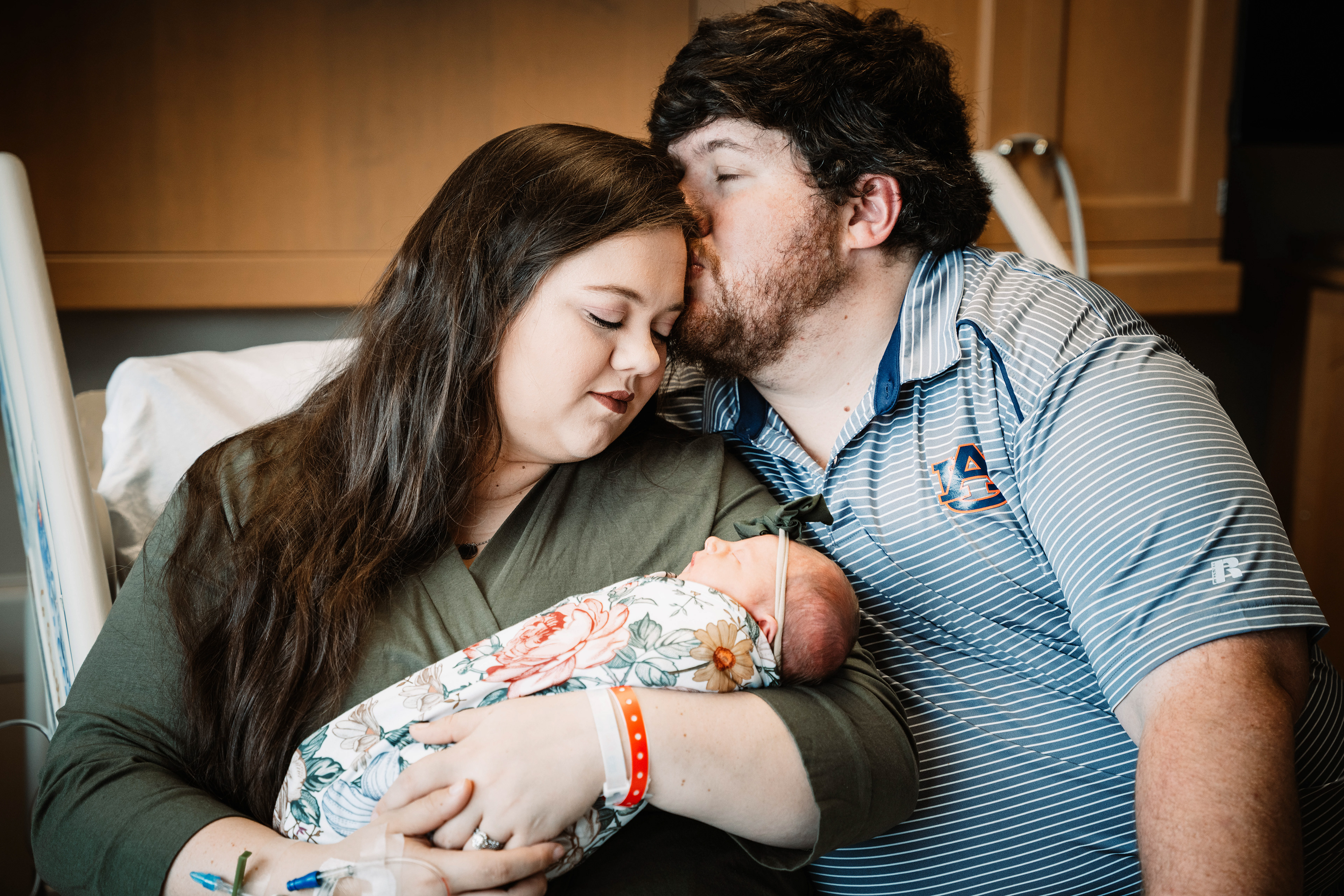New dad kisses wife on the head in first family photo