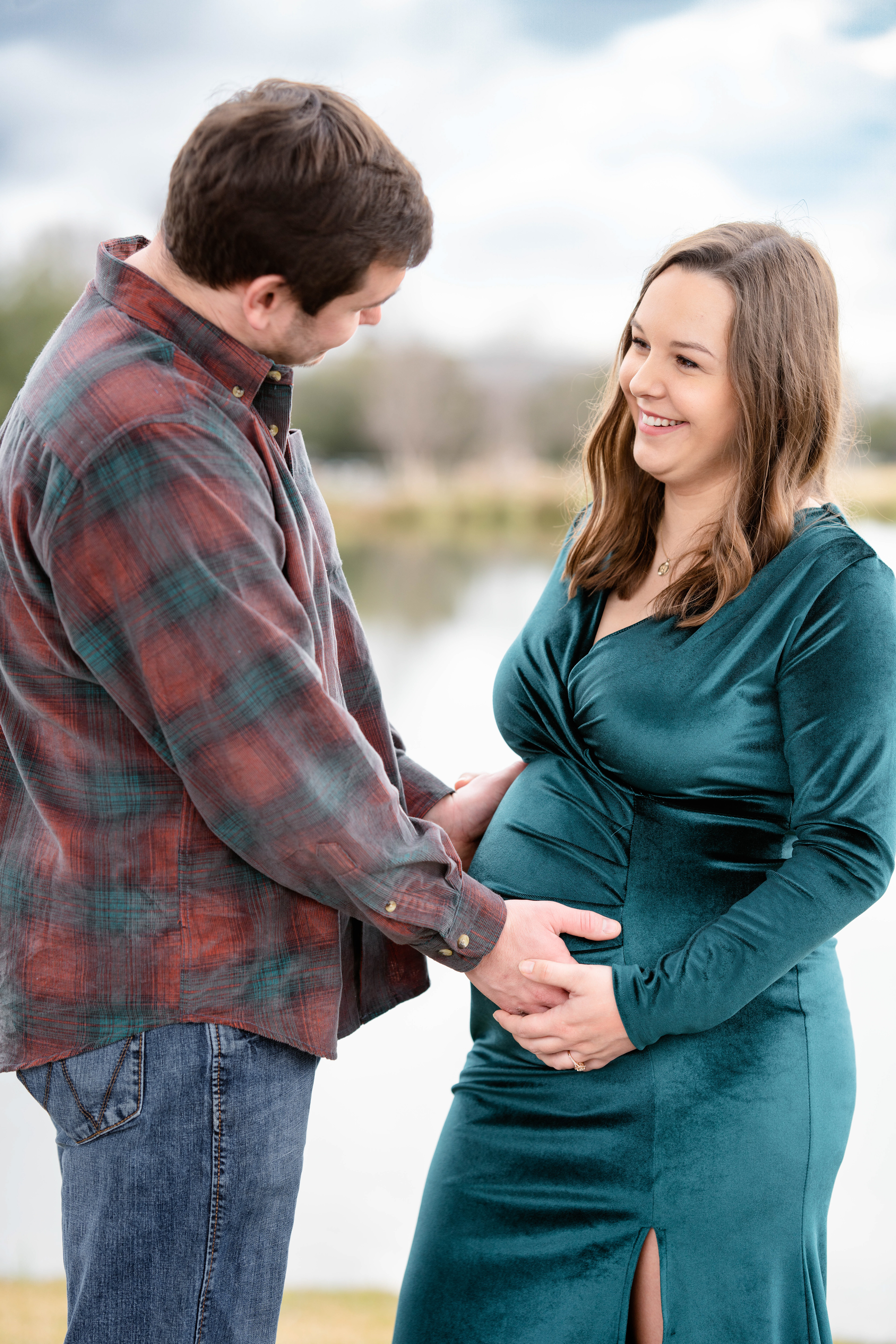 Husband feels pregnant wife's belly