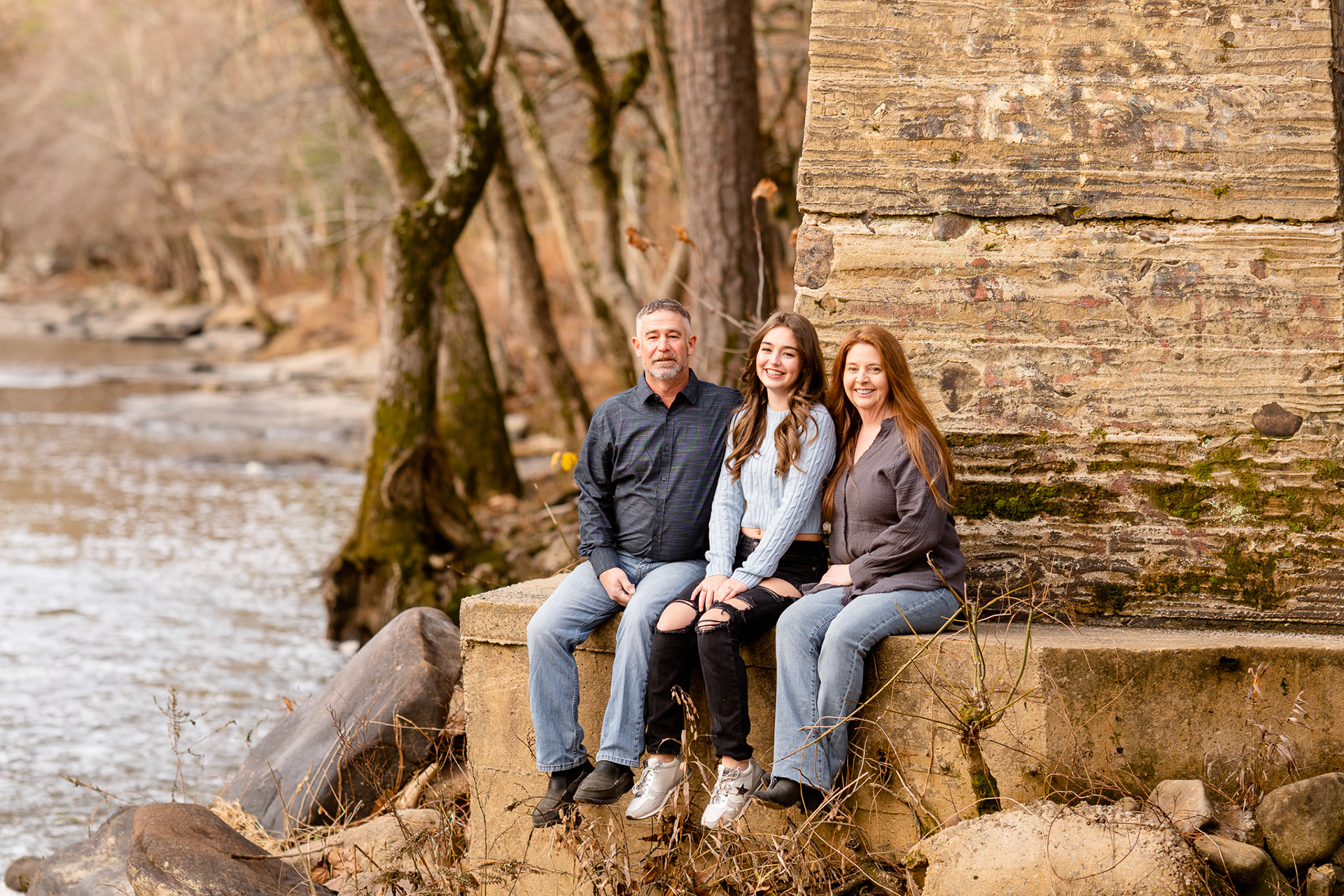 Family sits at base of bridge