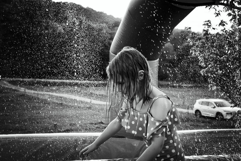 Birthday girl on inflatable slip 'n' slide.