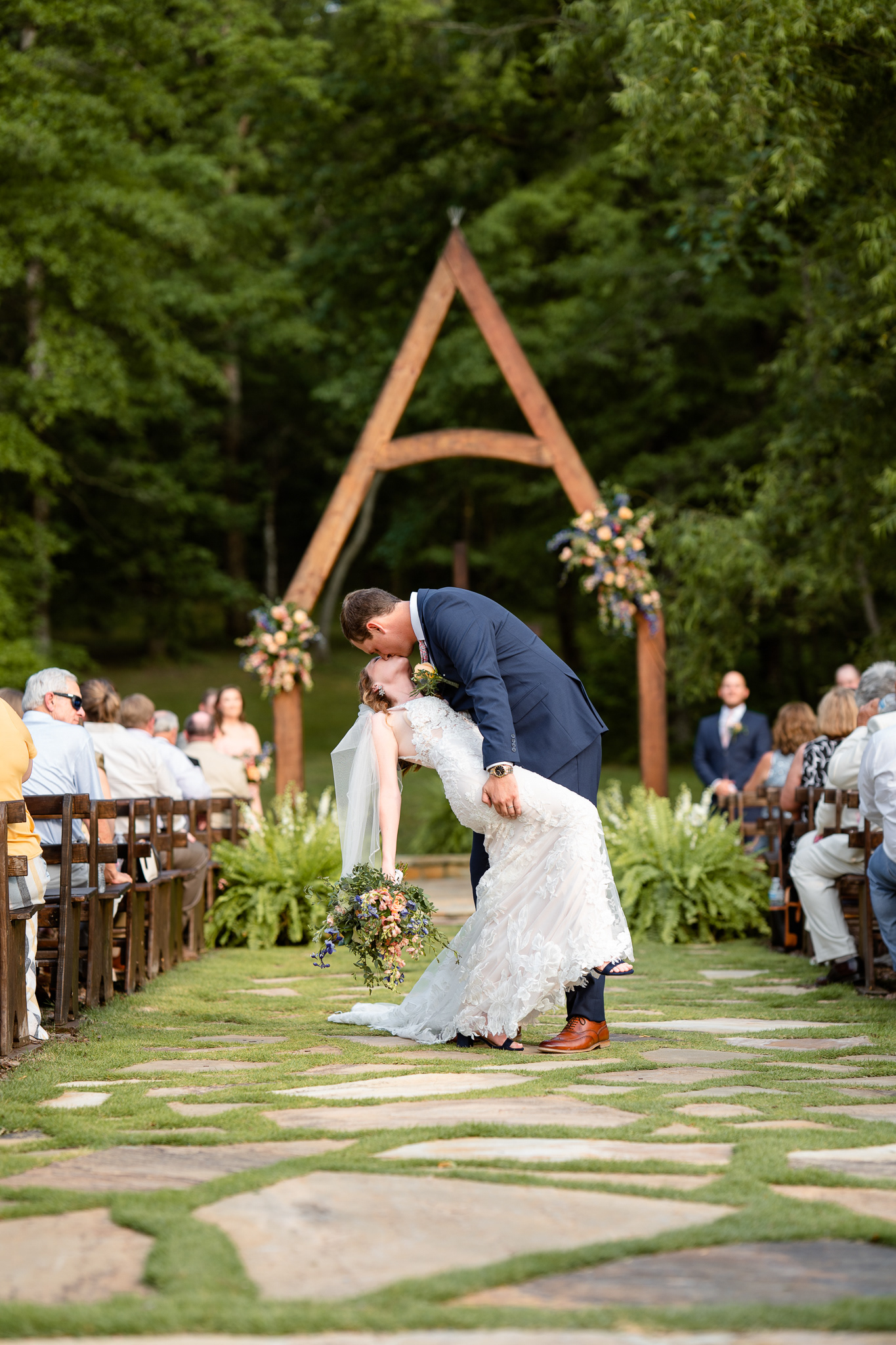 groom dips bride in the aisle after ceremony at Belle Farm in Sterrett, Alabama