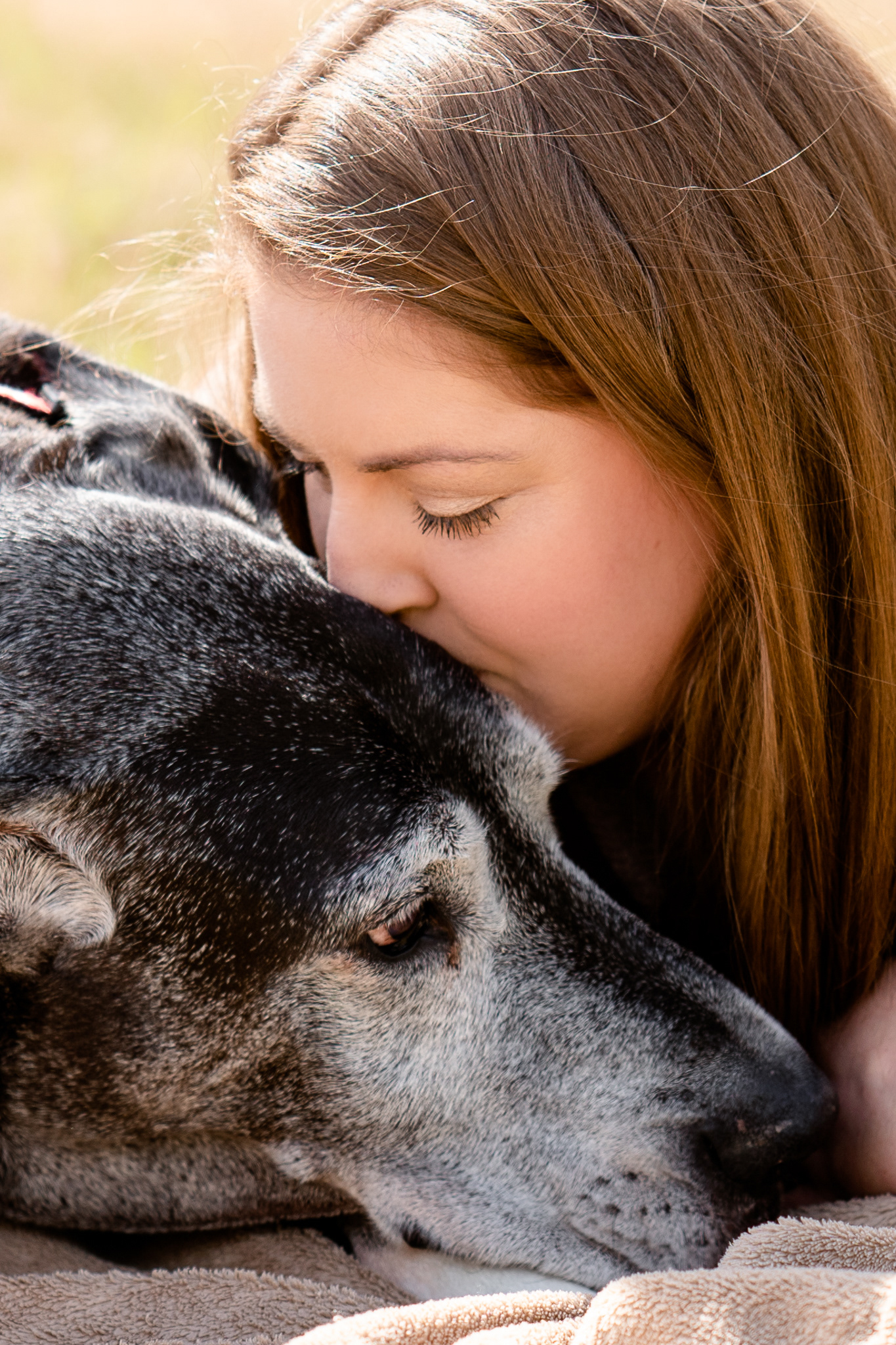 Fur mama kisses her elderly dog