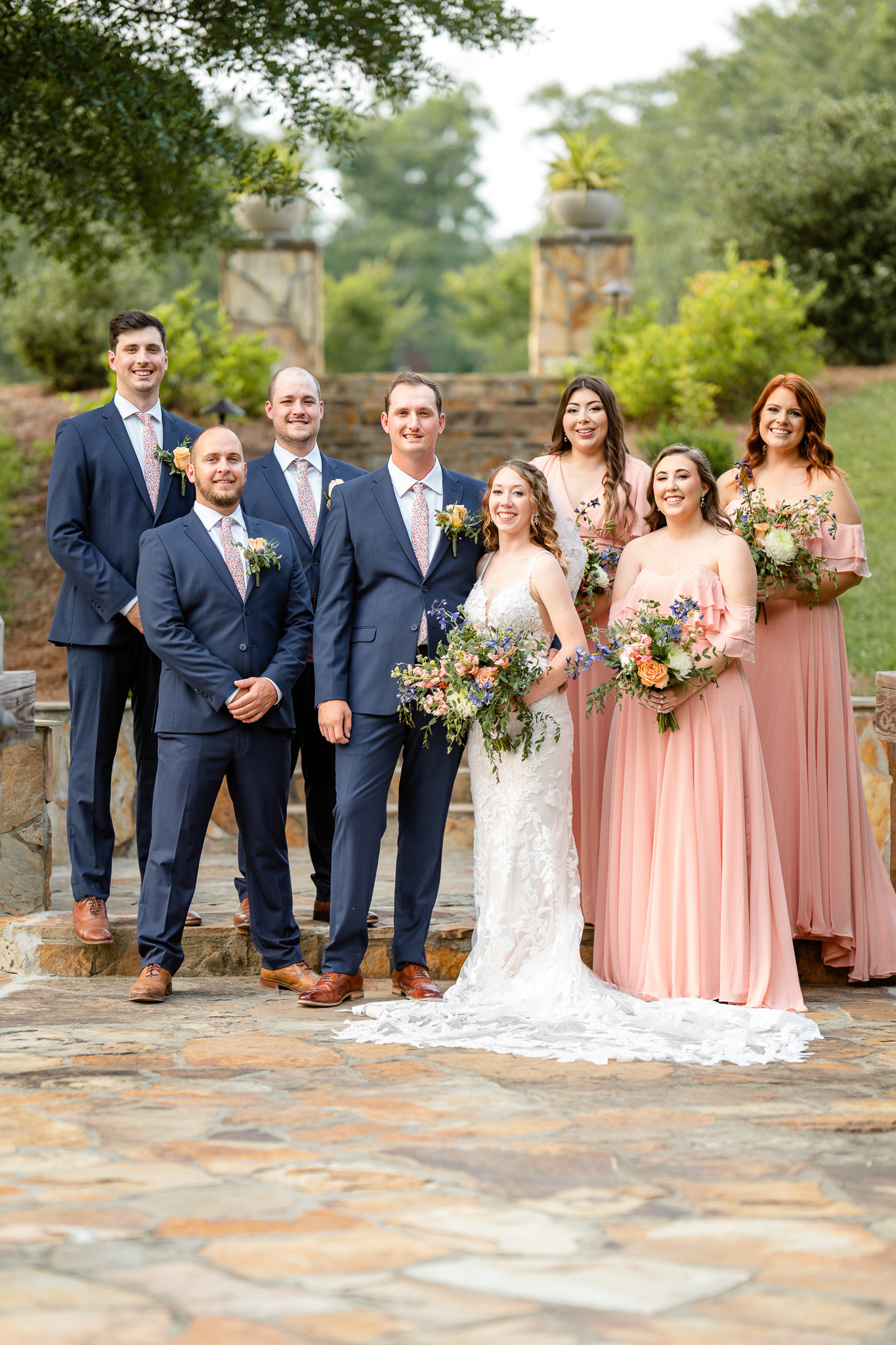 Bridal party with peach and navy color scheme
