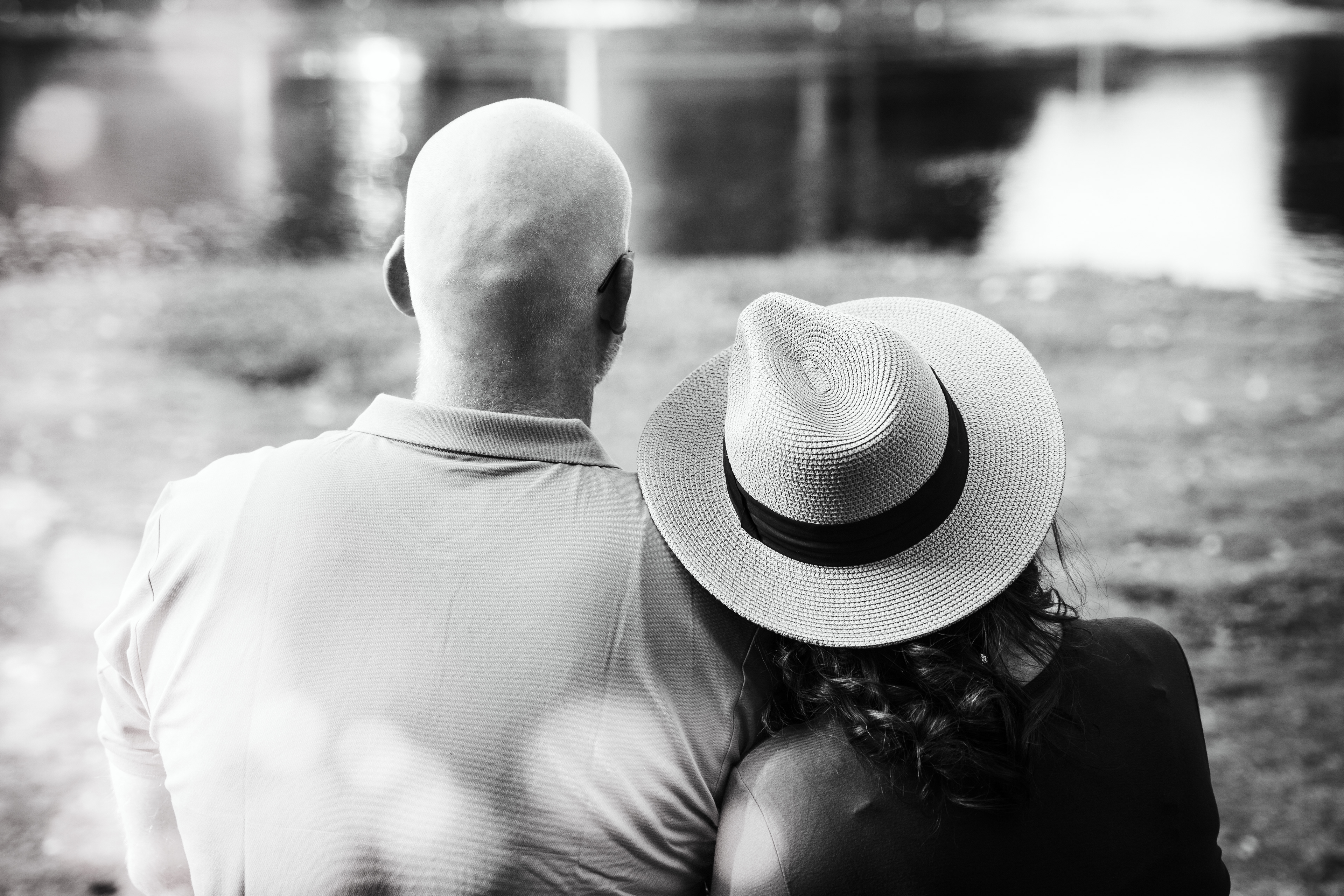 Man and woman sit on park bench