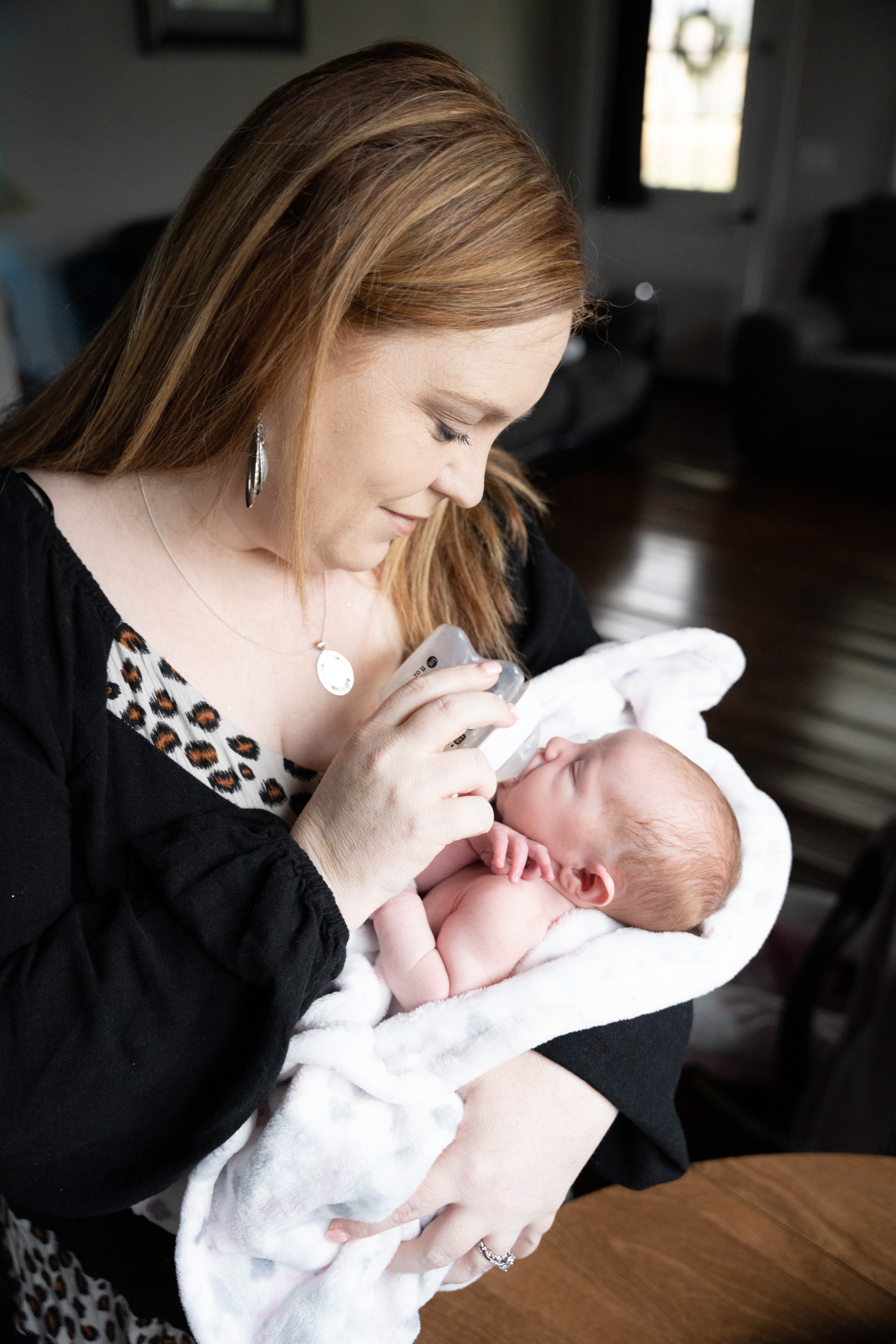 New mom feeds her newborn daughter