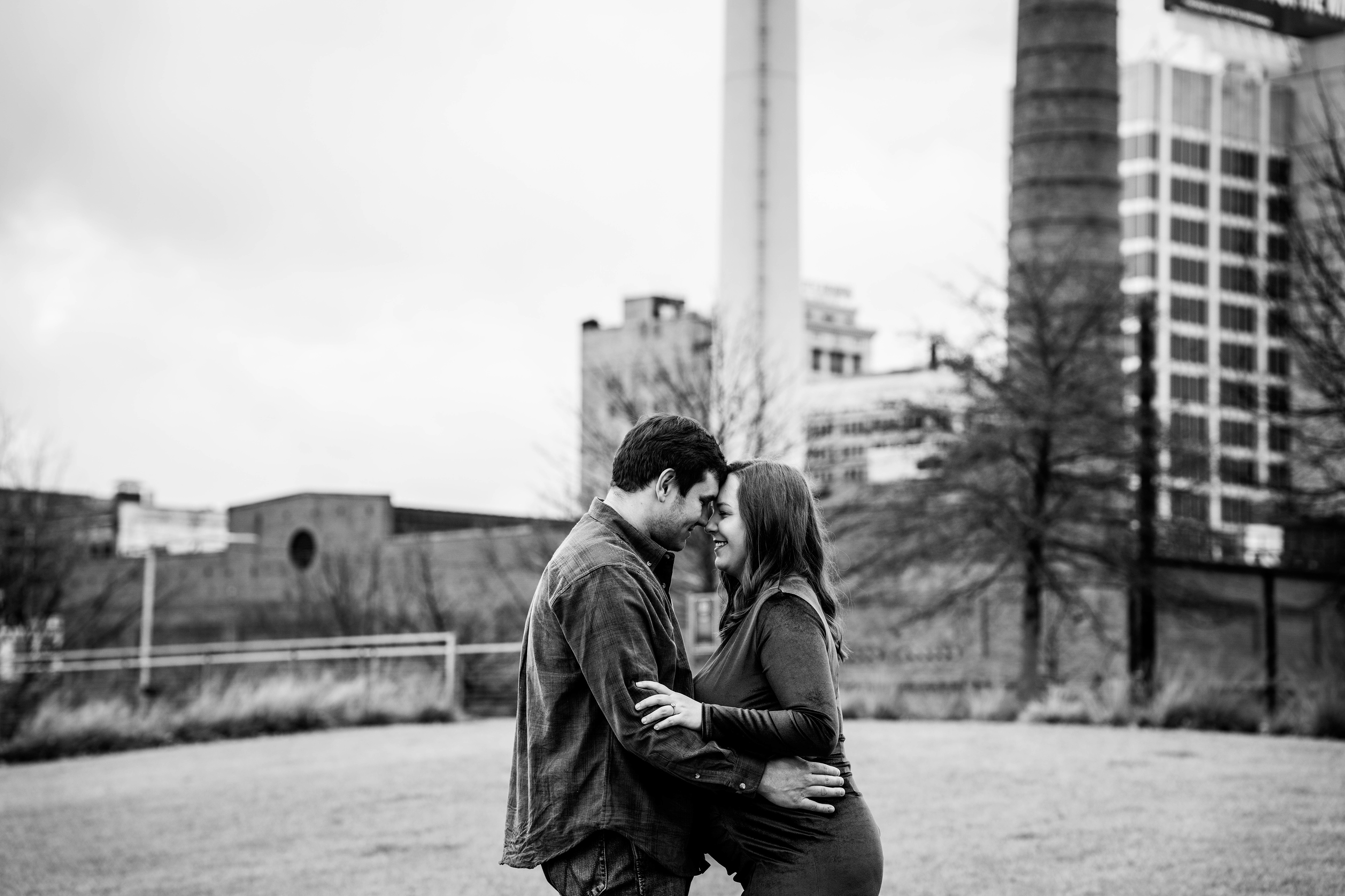 Couple cuddling with pregnant belly between them