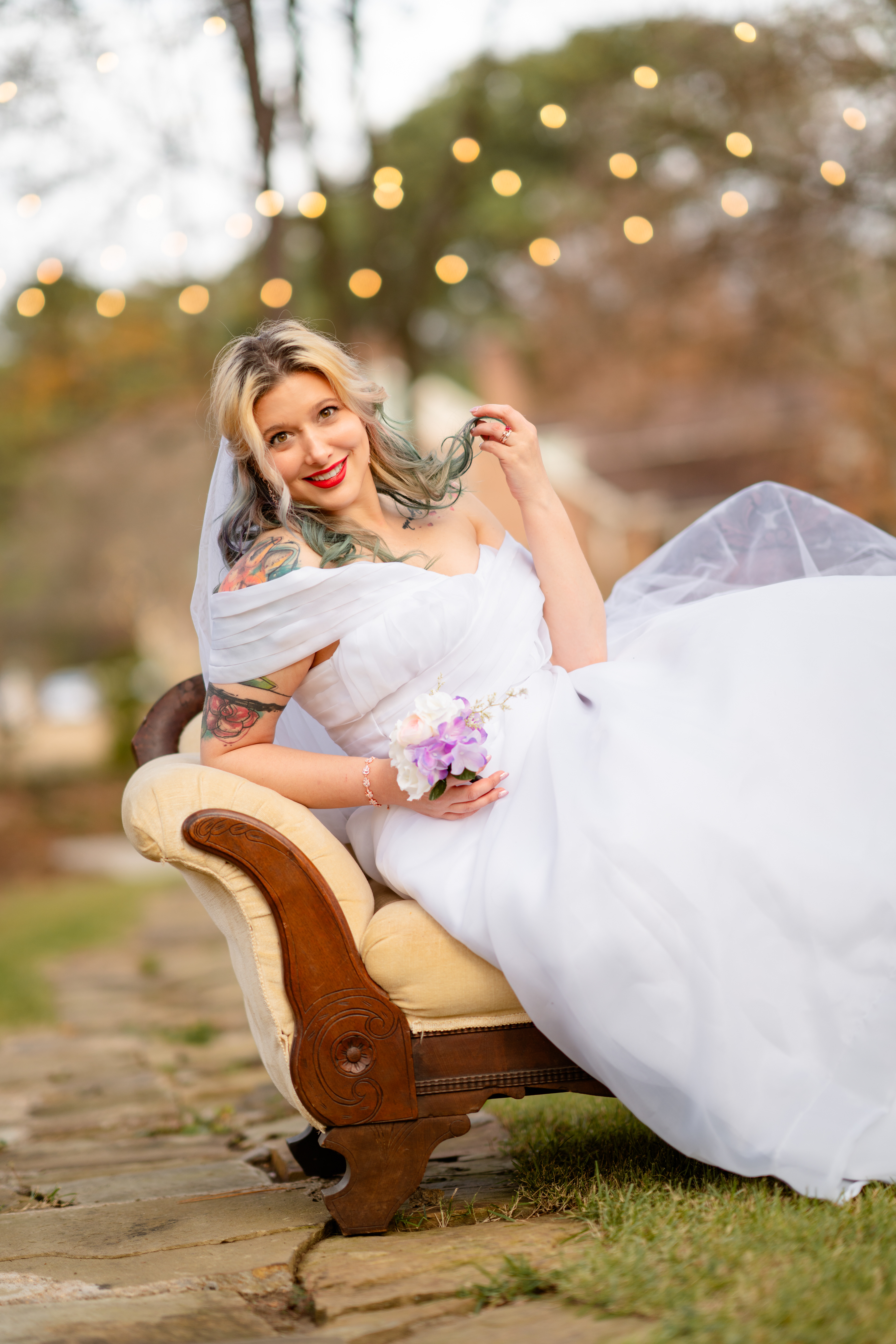 Bride poses on couch outdoors