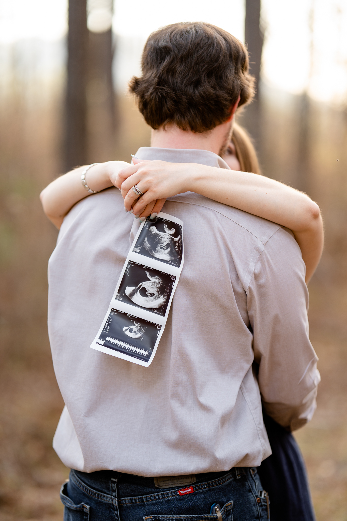 Couple hugging and holding sonogram
