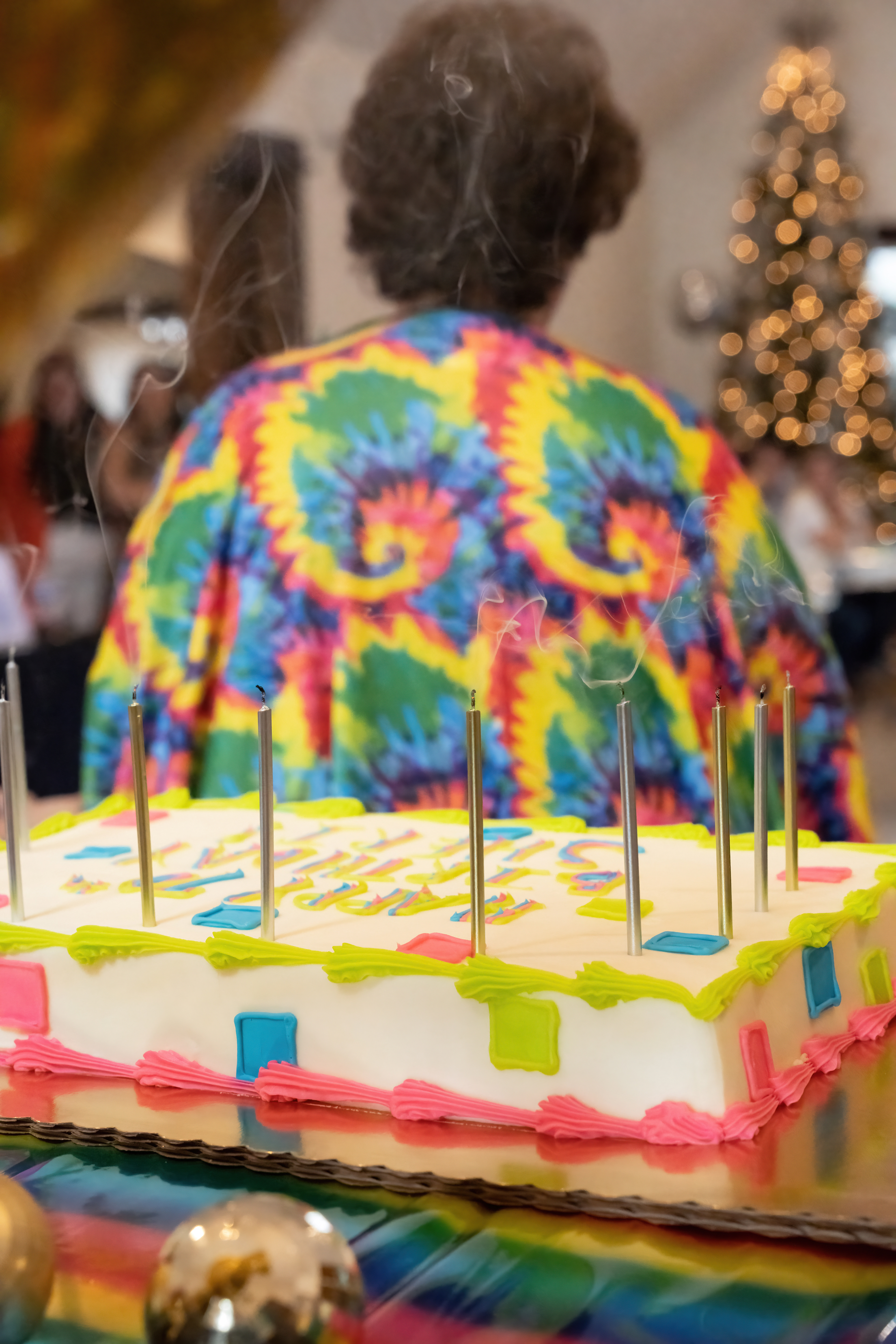 Extinguished candles with birthday girl in background