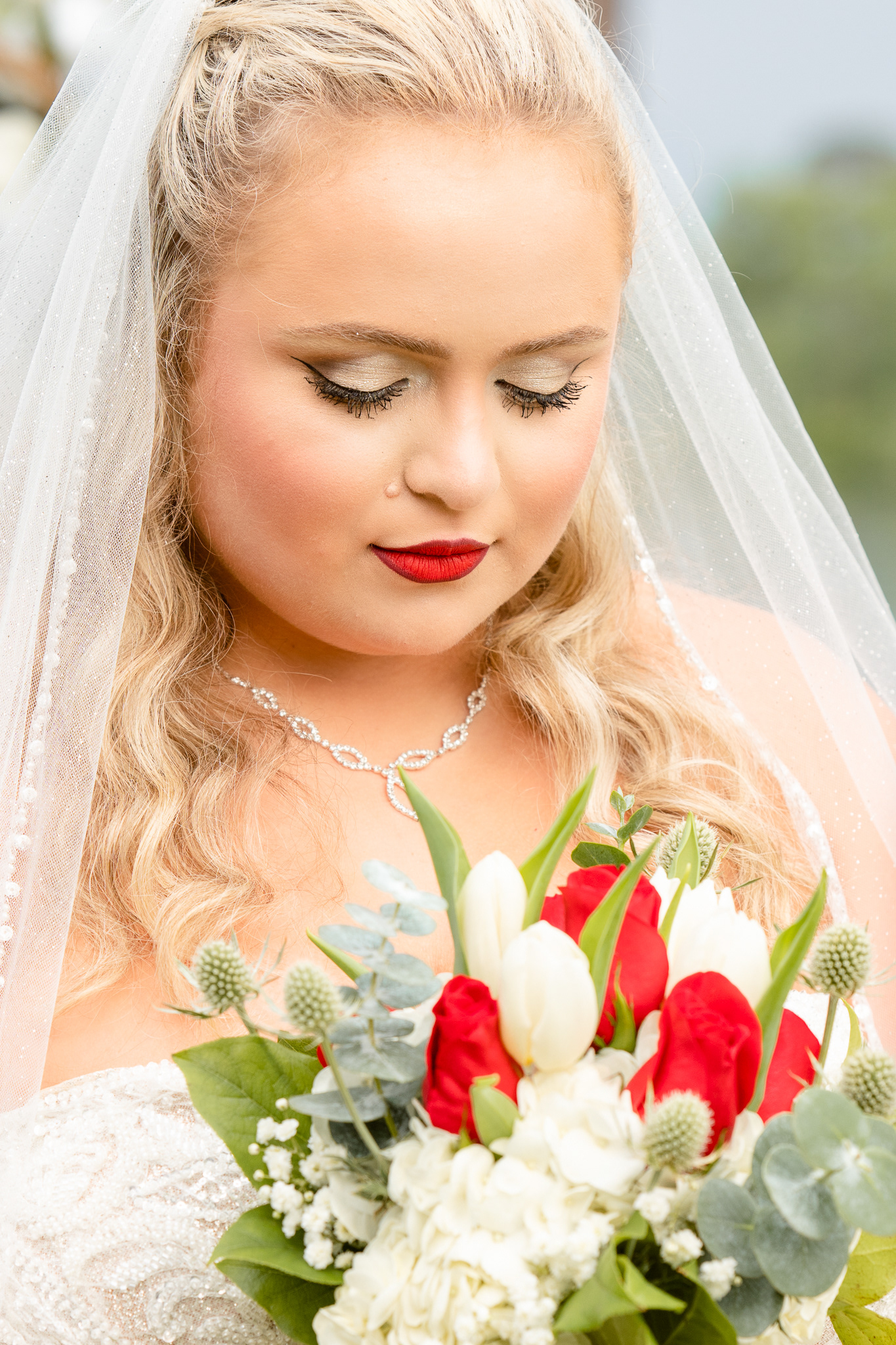Bride looks at bouquet 