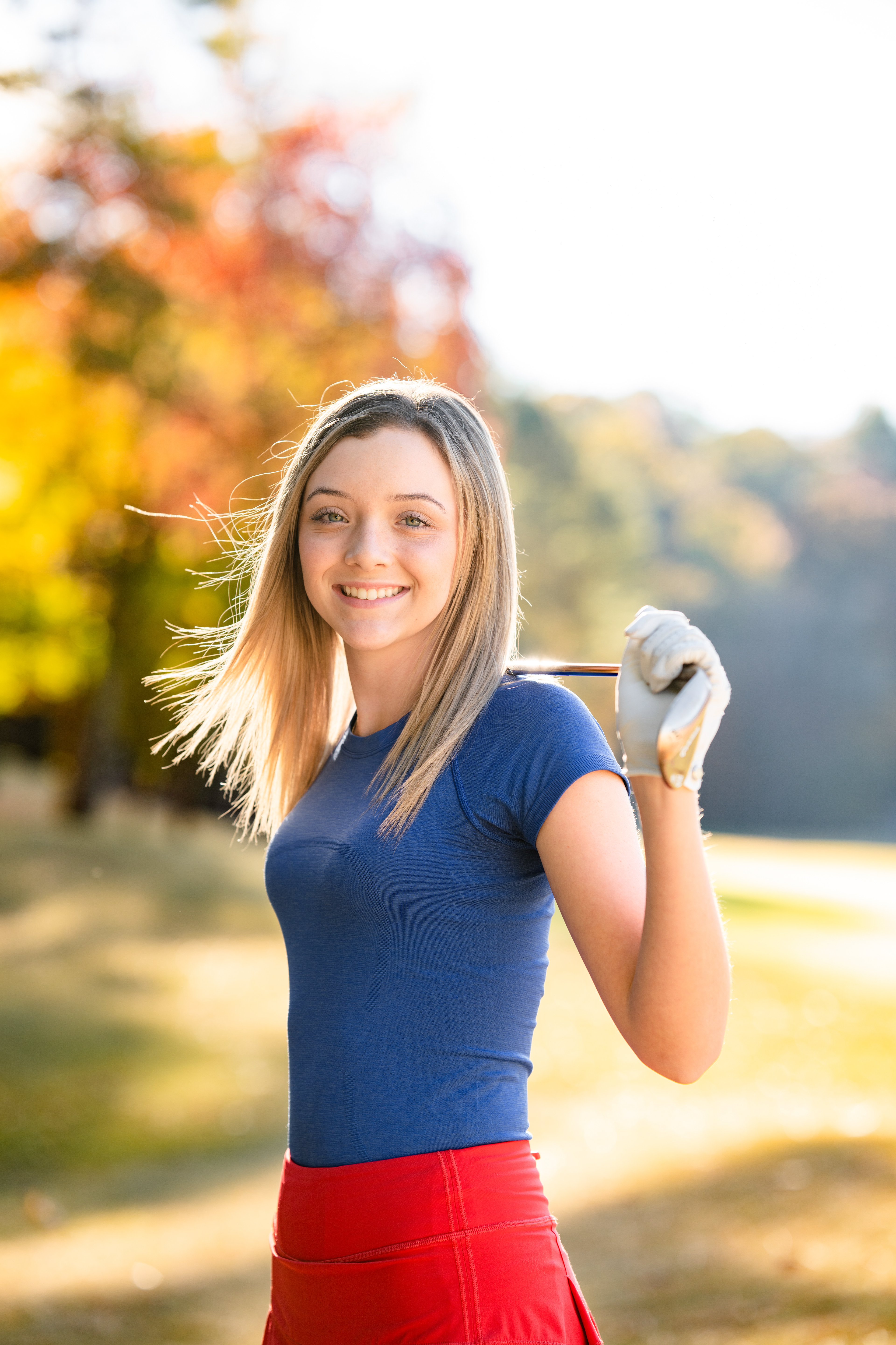 Girl golfer poses in fall