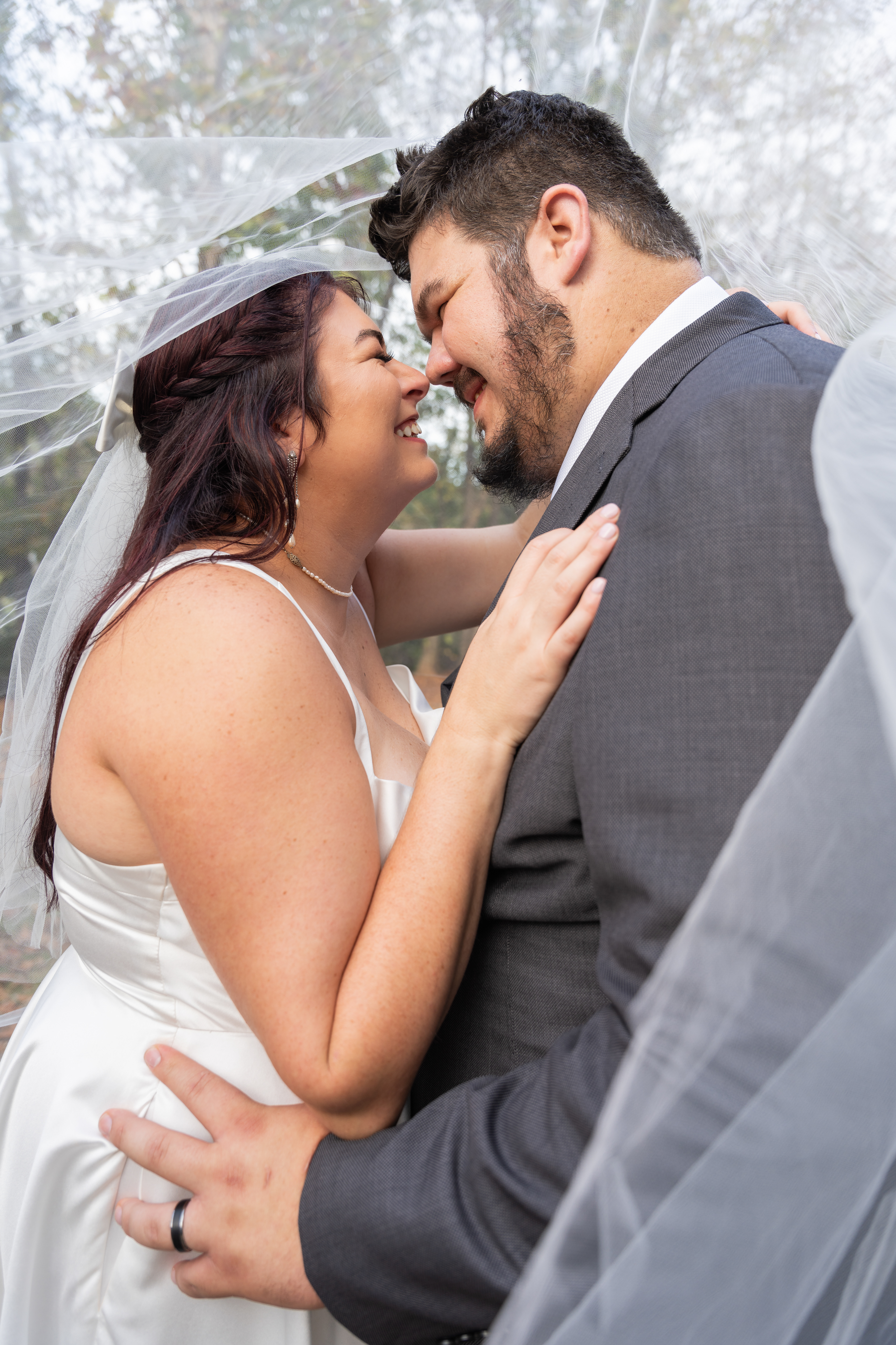 Bride and groom under veil