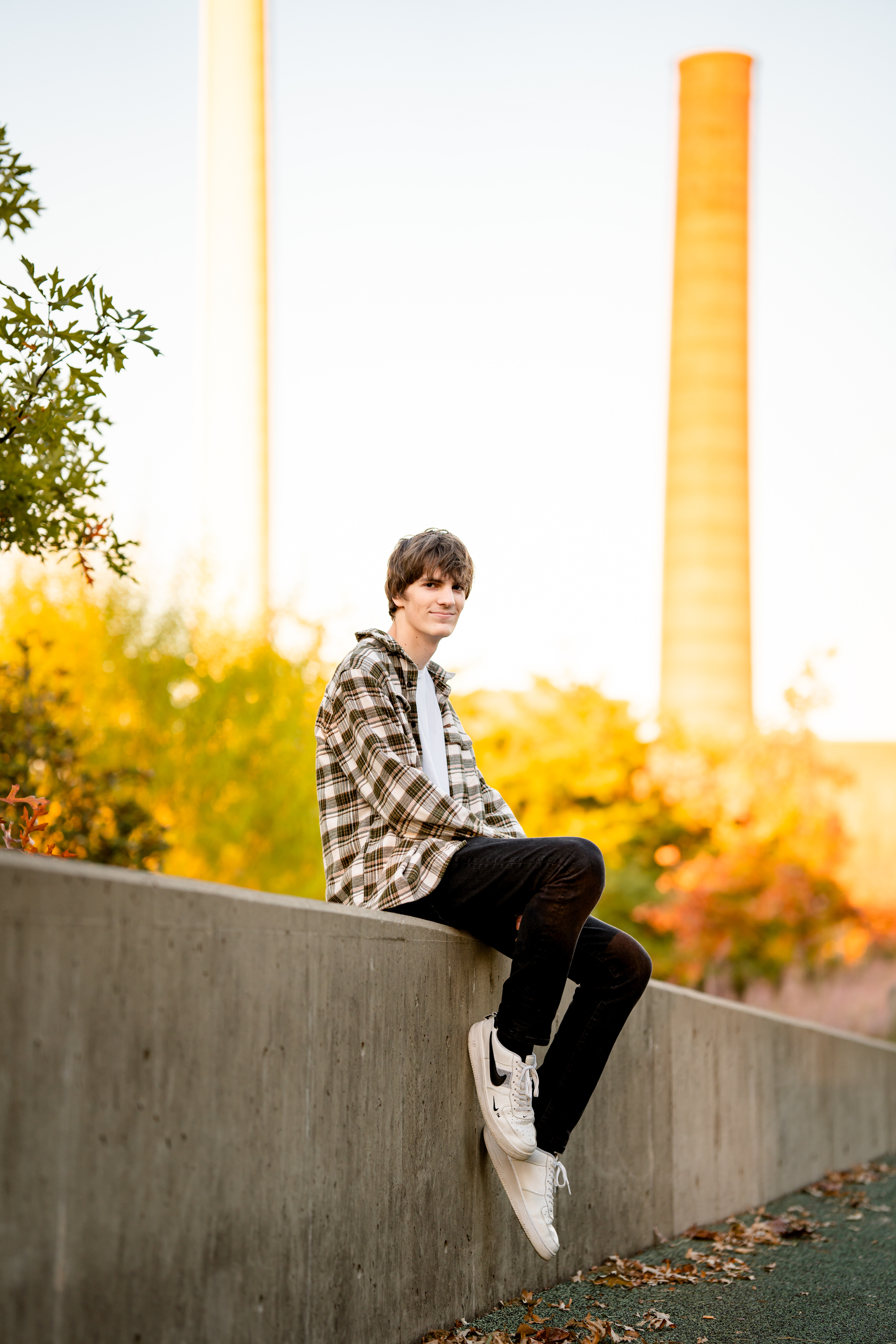 Senior boy with smoke stacks of downtown Birmingham in background