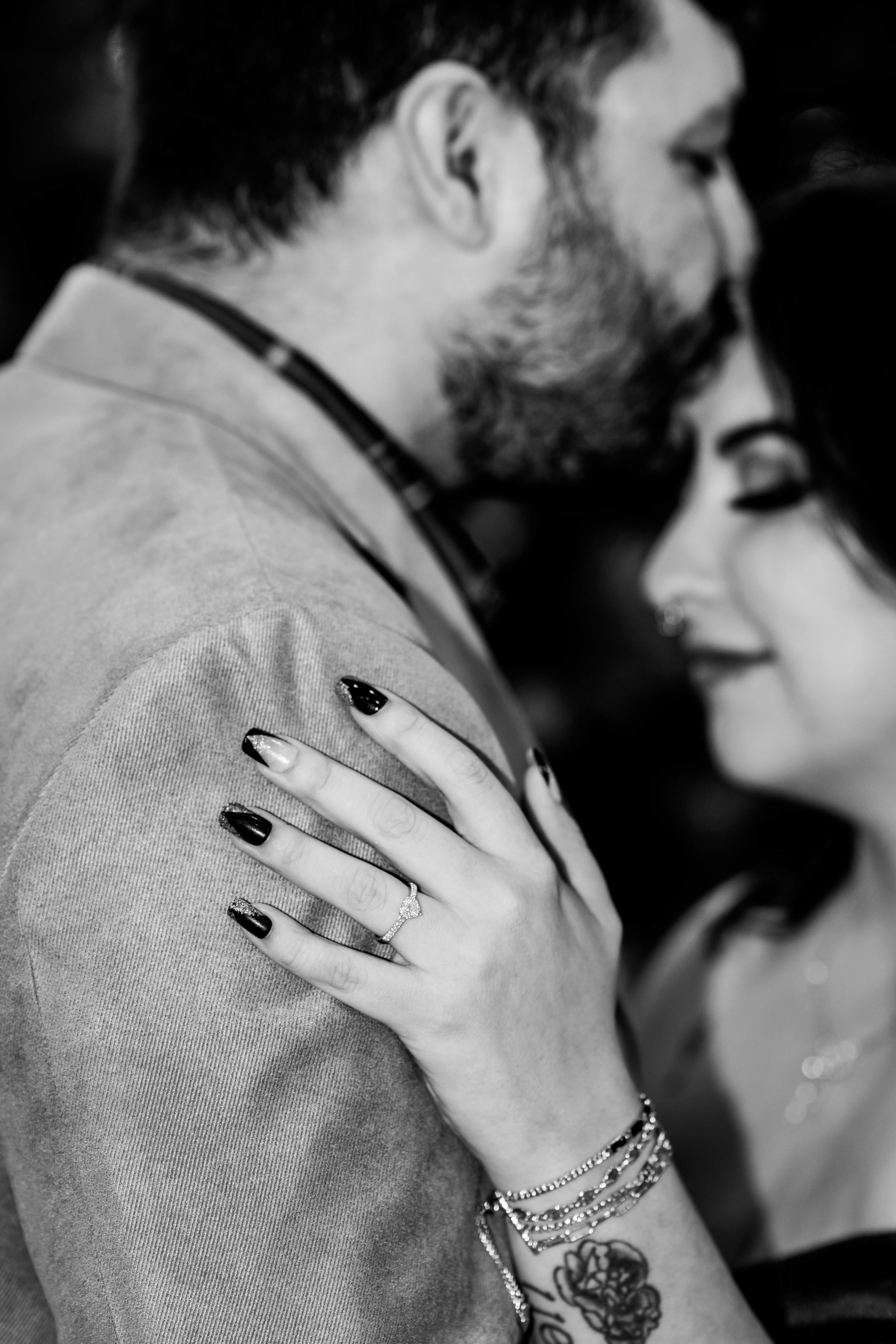 Loving kiss on forehead with focus on engagement ring