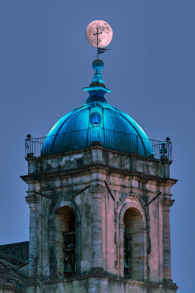 Cosenza, Italy - The moon behind the bell tower's cross