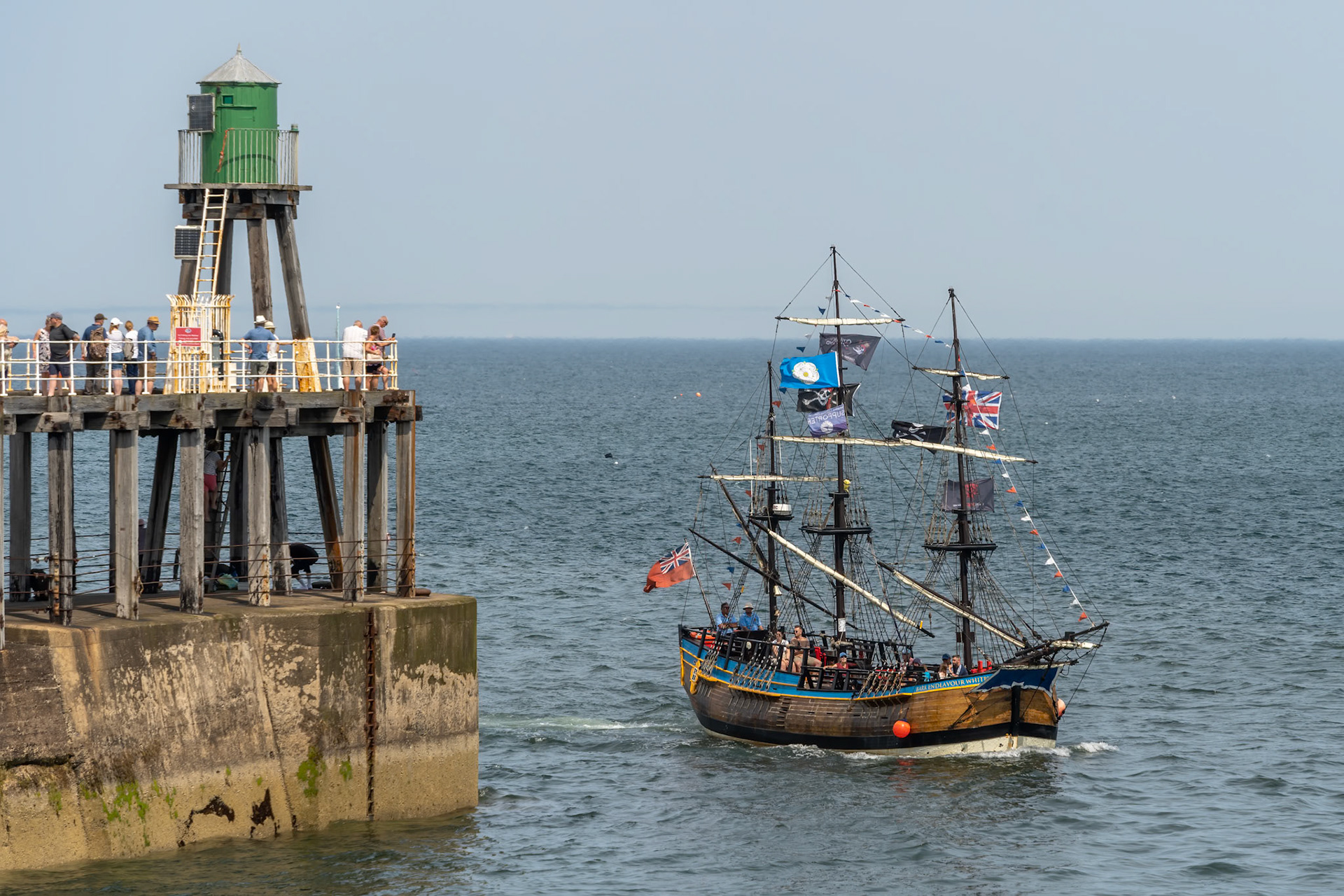 WHITBY,  NORTH YORKSHIRE, UK - JULY 19: Replica galleon pleasure boat heading into Whitby, North Yorkshire on July 19, 2022. Unidentified people