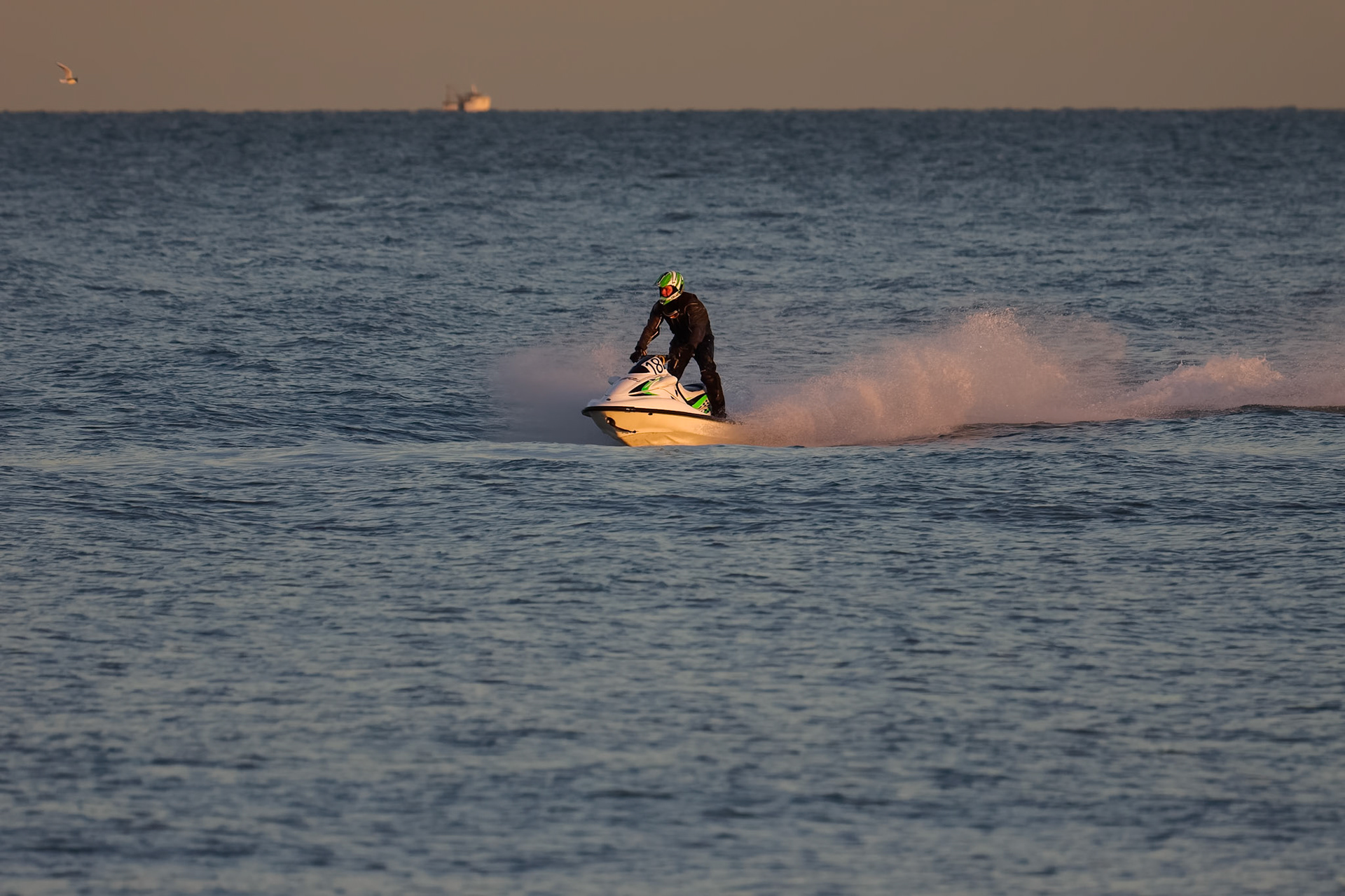 DUNGENESS, KENT/UK - DECEMBER 17 : Man riding a jet ski off Dungeness beach in Kent on December 17, 2008. One unidentified person