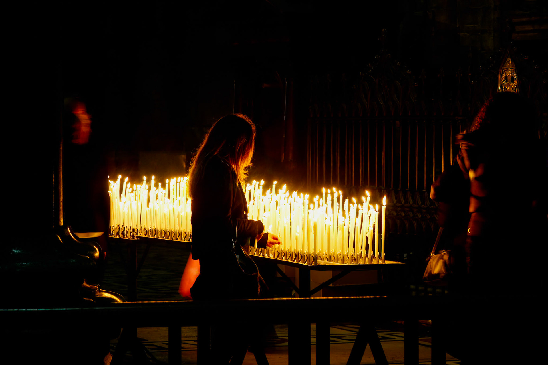 MILAN, ITALY/EUROPE - FEBRUARY 23 : Burning candles in the Duomo Cathedral in Milan Italy on February 23, 2008. One unidentified woman