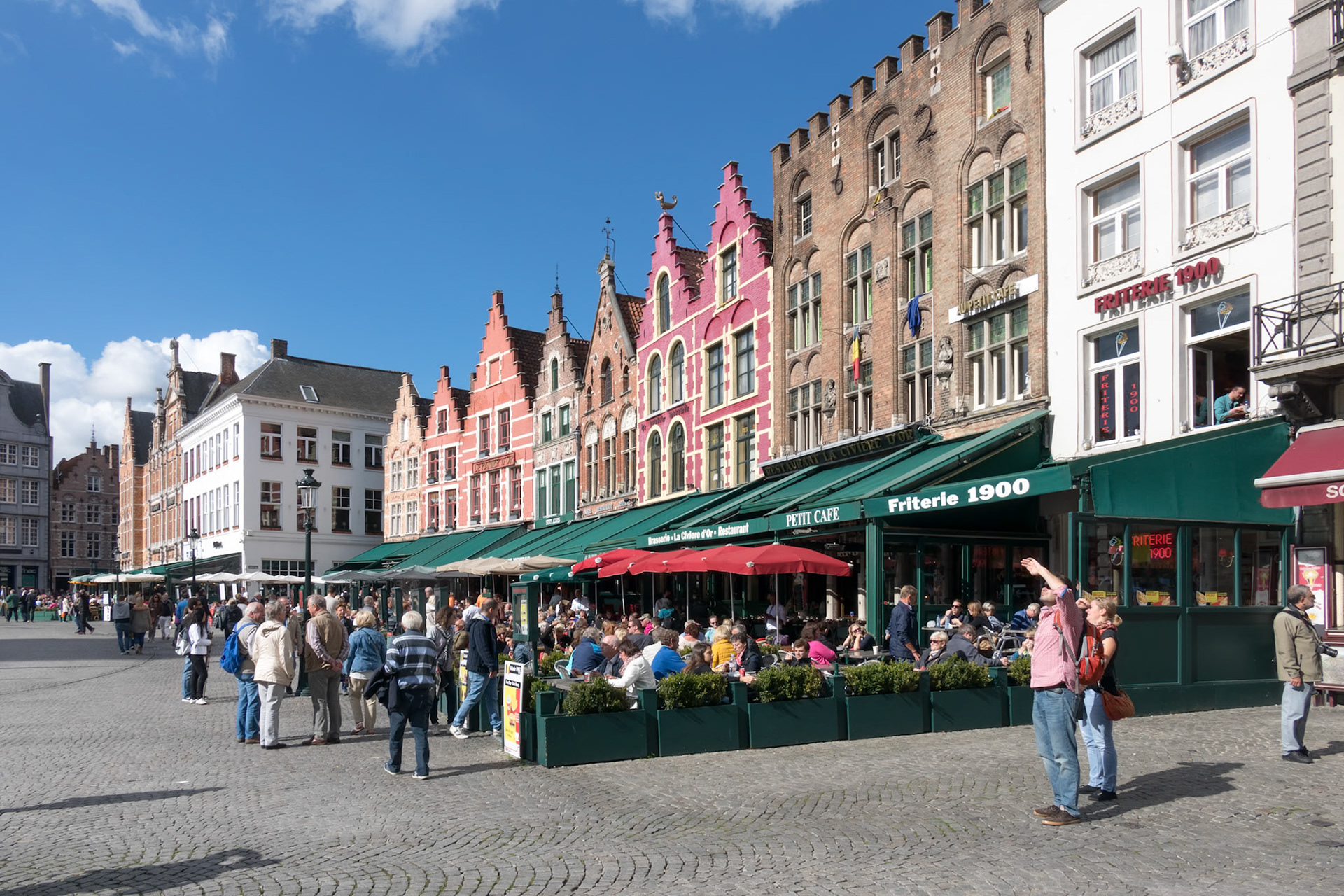 Historic gabled buildings and cafes in Market Square Bruges West Flanders in Belgium